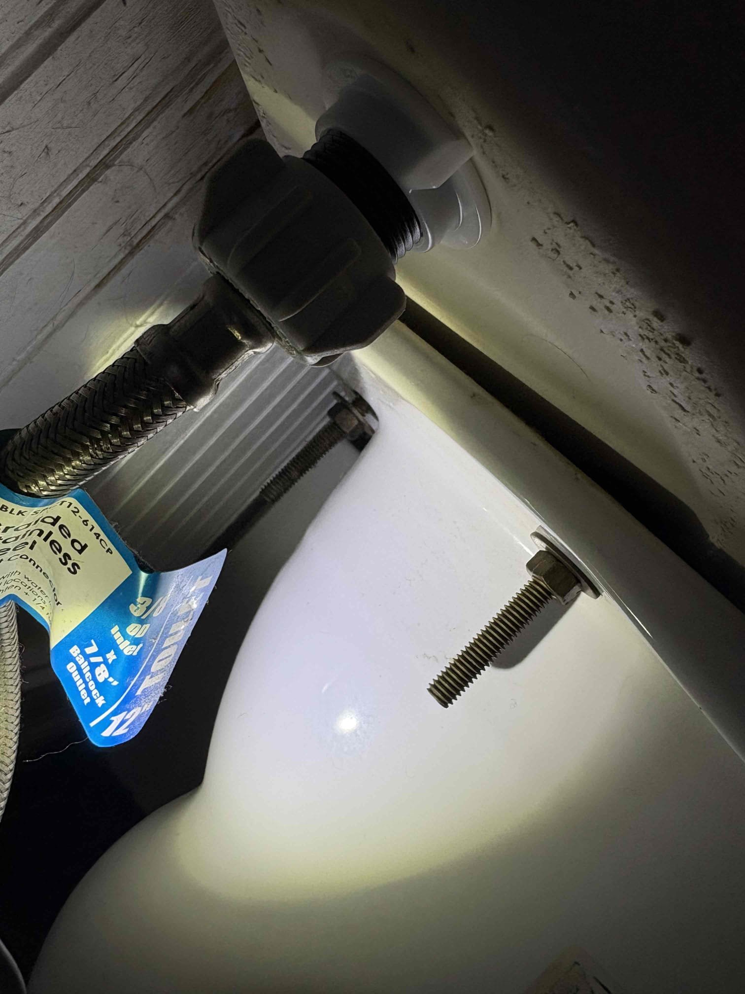 Called out today due to a small leak staining the kitchen ceiling, with the bathroom right above it. The stain was directly beneath the toilet and that drain pipe is cast iron. After some investigation, realized the toilet was not even secured to the floor and it was very wobbly. When we pulled the toilet up the toilet flange actually came up with the toilet which it is not supposed to do. To get client up and running we installed new mechanical toilet flange and secured to floor. New wax ring, closet bolts, and supply line, then sat the new customer supplied toilet. After fastening down tested. No leaks. Caulked around the base leaving back 1/3 open so leaks will show at the back if it does leak in the future. 

We did cut out that small section of stained Sheetrock to verify. There’s a couple copper water lines running right there as well. I wiped 1 drop of water off of one of the section of copper pipe but could never make it drip again. As a courtesy we cut out the 2 sections of co