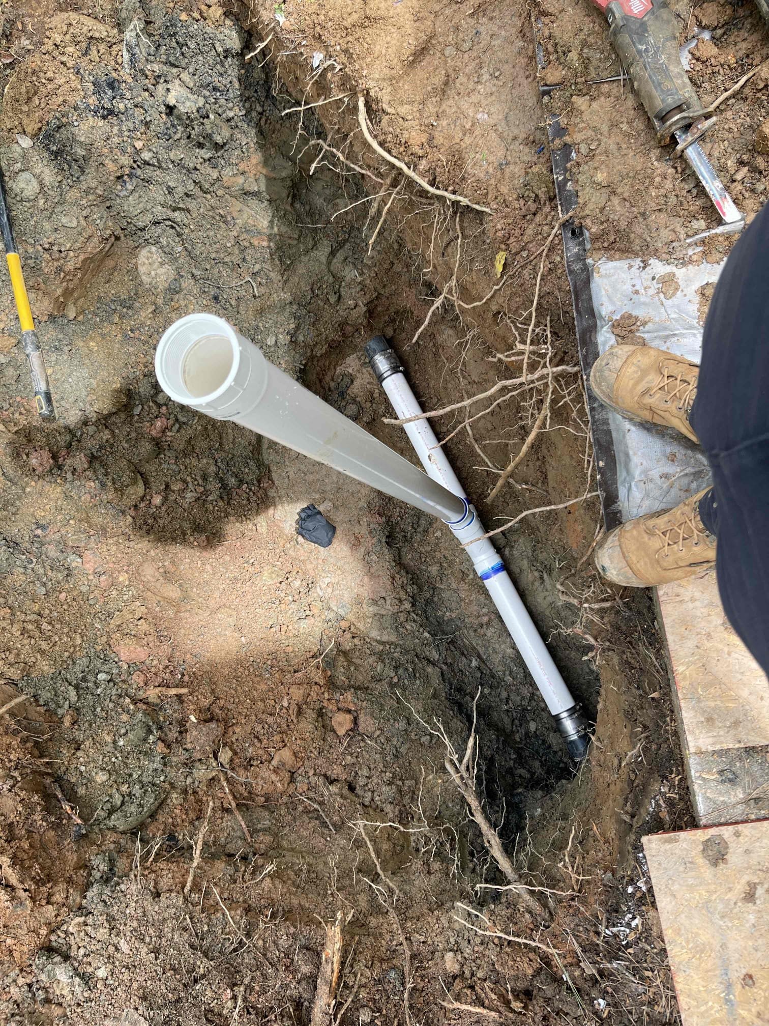 Dug down to pipe where we were seeing sewage come up out of the ground at. Found lots of chunks of asphalt/concrete buried around the pipe. Cleanout branch was cracked, which we took a video of. This was the source of the leak. Cut out the damaged section and replaced with 3” pressure pvc. Ran water inside the home annd tested repair to ensure the line was holding sewage with no leaks. Let the repair sit for 45 minutes while we went annd got more sand to ensure no slow leaks. Encased the shielded fernco’s with hydrostatic foam. Bedded pipe up to 6” above and below the pipe with sand. Backfilled by hand another 1’ of dirt above to ensure no rocks were touching the pipe. Backfilled the rest of the soil, tamping every 12”. Replanted the bushes we removed back in their original locations. No further issue at this time. No warranty on the repair due to it being a lift station ejection line. Homeowner was made aware of this. The break on the pipe was not on the discharge line itself, but on 