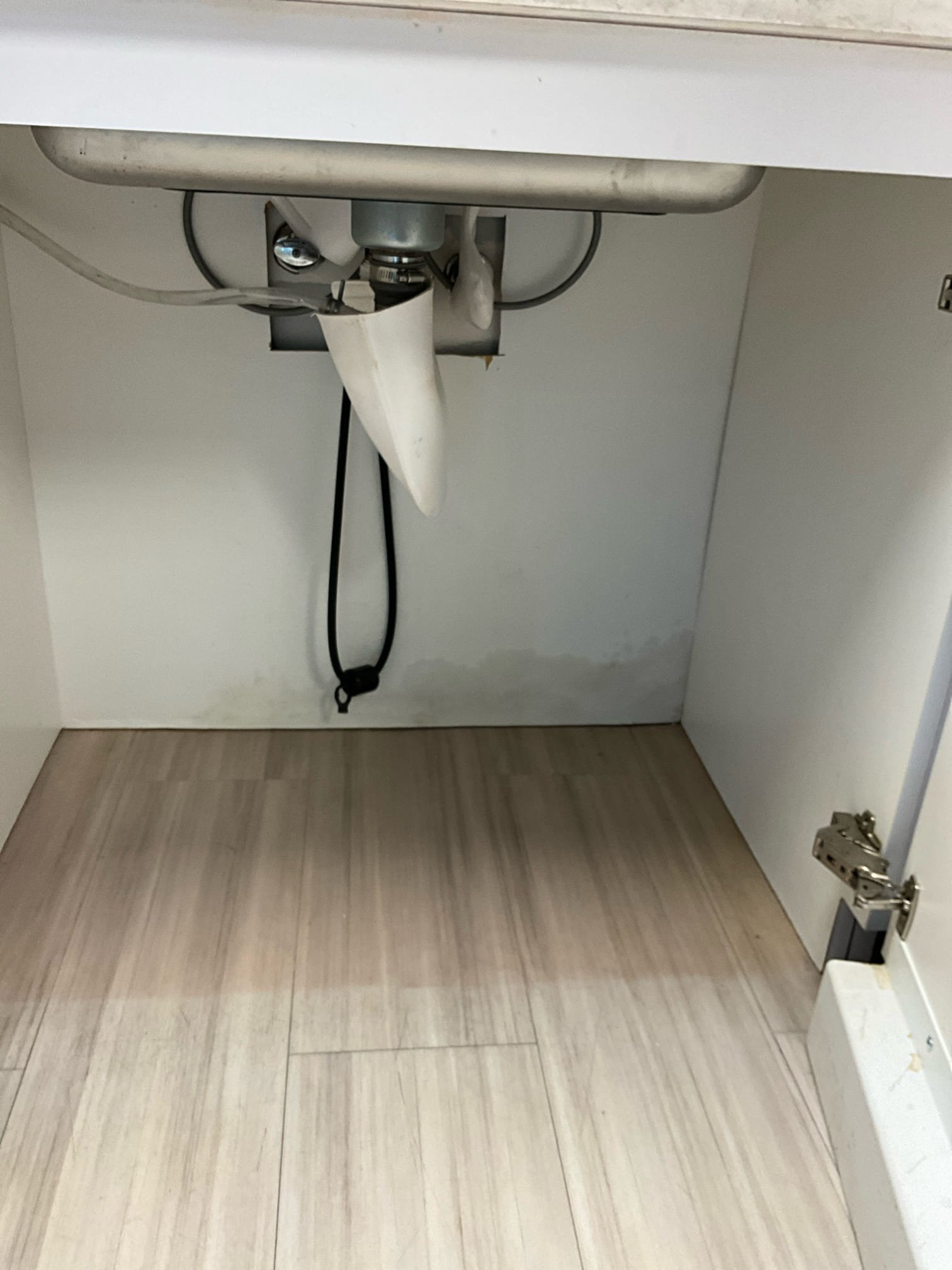 Call for drain leaking after ice maker installation.

Arrived and met with Chad on site. He states that after a vendor installed an ice maker they noticed a leak under the sink.

I inspected the sink and found that the trap was leaking from the ice maker branch.  Due to the height of the drain exit in the wall, the sink configuration, and space restrictions we were not able to install a dedicated p trap for the ice maker. I replaced the nut on the basket strainer, and reconfigured the p trap to accommodate the ice maker condensate line.  This work was done under warranty.

During this we also discovered the line was backed up again. 

I used small auger and bent in a Z to scrape coffee grounds and residue off the interior of the pipe walls. Inspection camera used to verify as far as possible. Due to configuration of drain lines we were required to cut vent line in ceiling to auger the drain further. Drain was cleared, water ran for approximately ten minutes to verify no further blockag