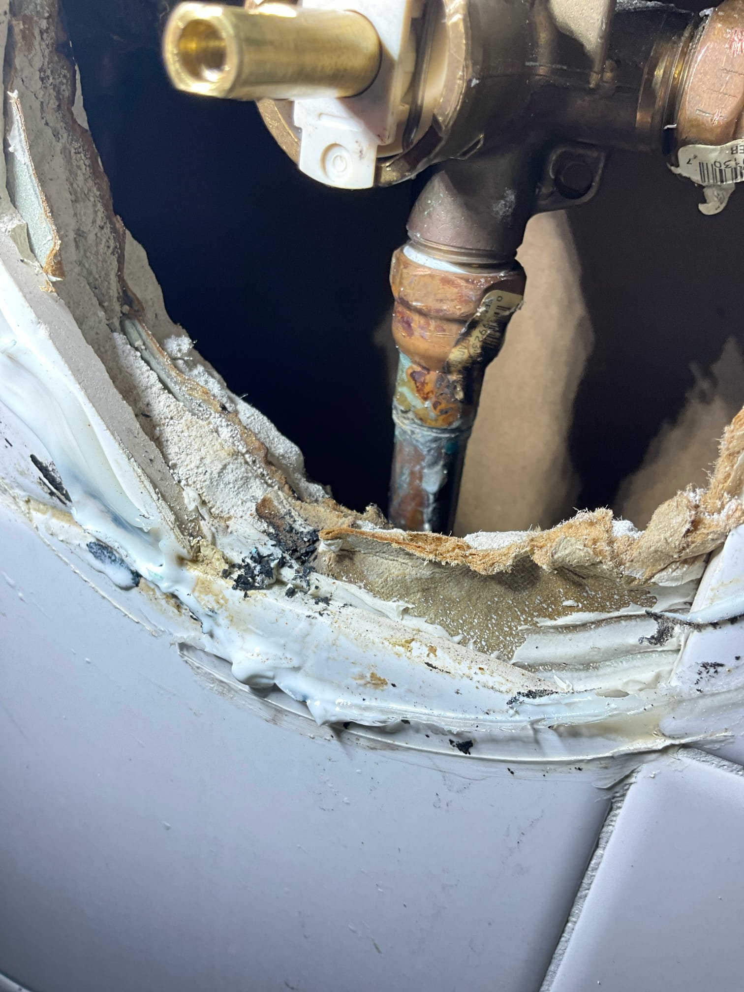 Call for water in ceiling after recent shower cartridge repair.

Arrived and found water leaking from kitchen ceiling. Water was still on to home. It was stated that when the shower was used they noticed water, but not when the tub was used.

I inspected the shower by removing the escutcheon and trim. When carefully testing we found the copper pipe going to the tub spout was not all the way in the female fitting. Photo is on file showing the pipe, and you can see the solder line. The spout pipe was bent at a hard angle and putting tension on the improperly soldered joint. We also noted poor soldering and damaged pipe at other sections of this shower valve.

We performed a repair at no cost as a courtesy and demonstration of our commitment to quality customer service. We have contacted Provision Restoration and they have arrived on site and are taking care of the drying and repairs at no cost to the customer. 

We tested all functions of the shower and tub, ensured no leaks were present