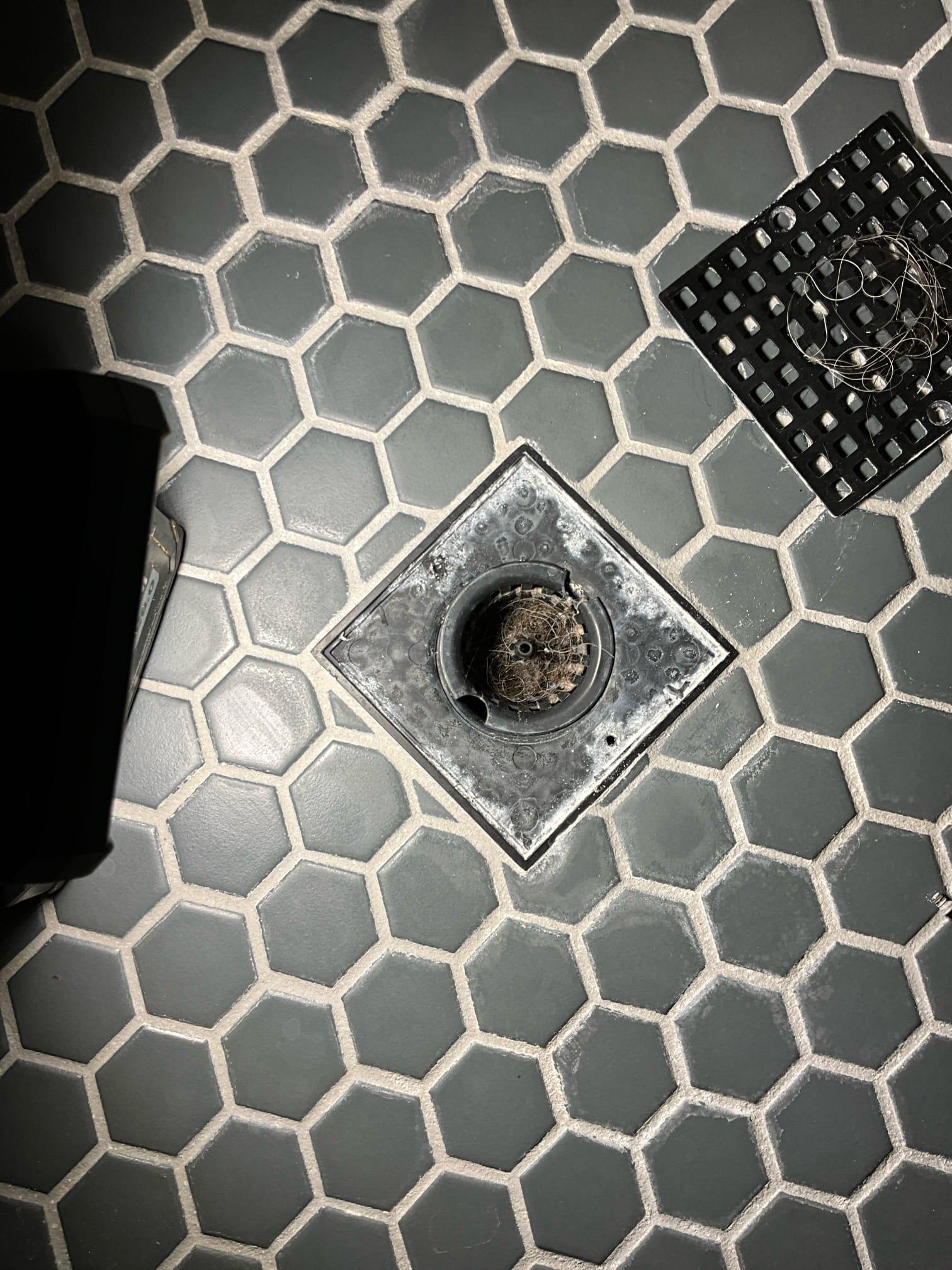 Call for slow shower drain. 

I arrived and discussed concerns with Mr. And Mrs. Singh. They stated that we have been out before to clear the master shower drain (approximately two years ago). Shower was remodeled nearly five years ago.

I inspected and what a grout like substance occluding nearly the whole drain. Substance was grotty and sandy, but had some plastic feeling tubular pieces as well. I was not able to identify the issue. I contacted a general contractor to advise us on possible grout or tile issues that could cause this, and they advised that grout color cover layer may be slowly piecing. But that no other possible scenarios came to mind.

I discussed concerns and possible solutions with Mr. Singh. I stated that we could attempt to chip it off as best as possible and vacuum the bits out, if that didn’t work we would have to remove and reinstall p trap. 

We were successful in removing most of the blockage, with residual grit clinging to walls but not effecting draining.

