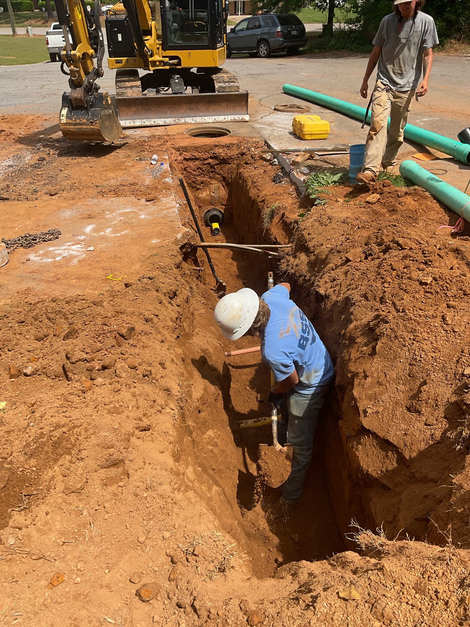 For this job , we cut street installed 6” ductile sewer lateral line with core into manhole and drop down to bottom and used special hanger for proper support , new line continues to customer property with a 6” clean out installed, this job is permitted and inspected by Gwinnett county . 