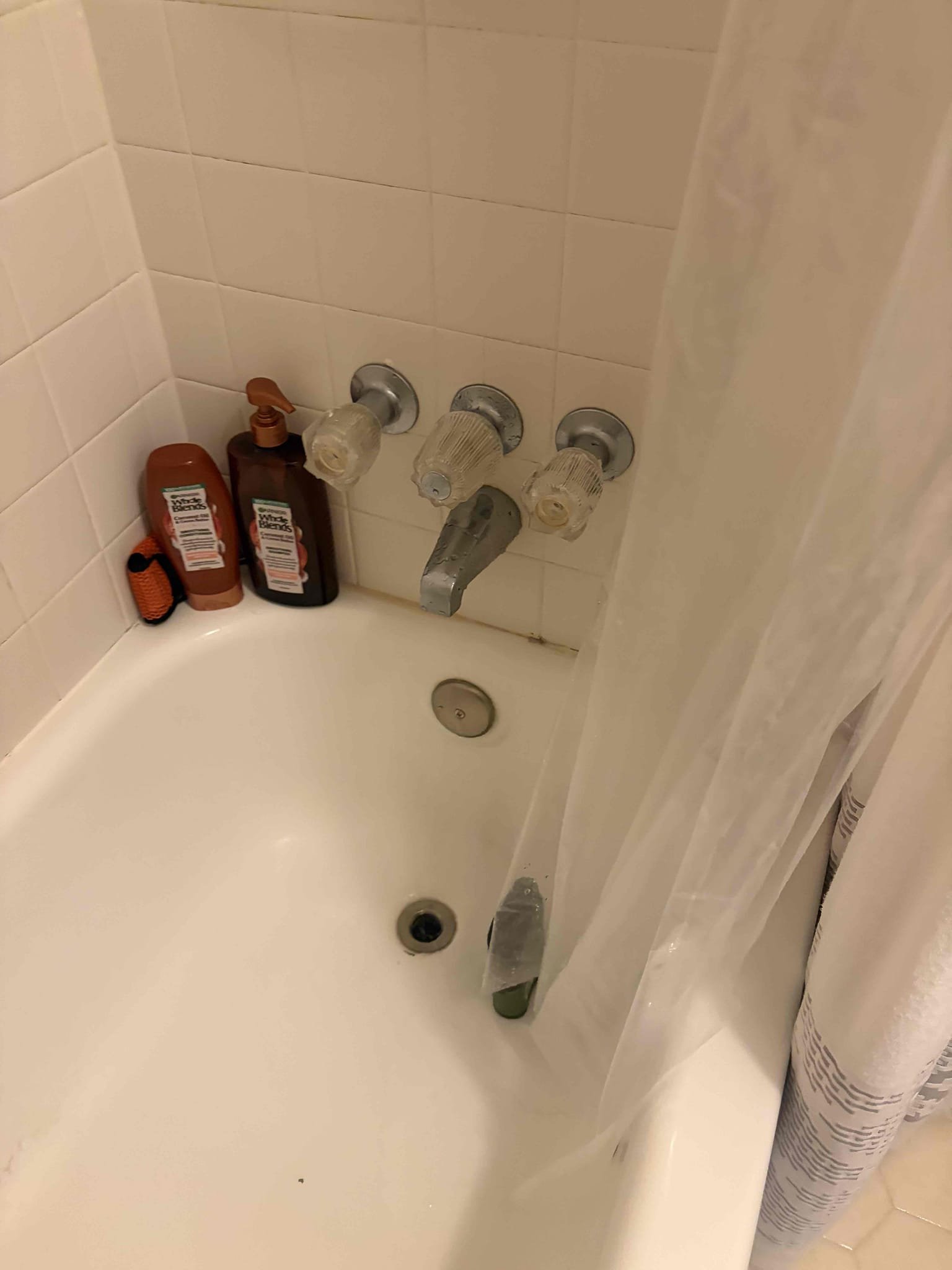 For this job, they have a three handle shower valve in both bathrooms upstairs the valves can be repaired however, we do not repair them anymore. We can only replace the three handle valves with a single handle valve to bring it up to code compliance. There are no access panels behind the walls due to the fact that the showers are both backed back in order for the proper replacements. We will have to cut a 4 x 5 square-foot section of tile to remove and relocate the shower valve to a higher location and also install the valve properly. We would have to convert from a three handle to a single handle and gave the customer a couple different options of what we can do the customer is wanting to find a tile contractor before proceeding with the work just so that they would have one on standby for when it comes time to install the new tile so they can use their shower. Water pressure is fine at 50 psi, additionally the water heater is still from 2007. It looks like they got it fixed by handy