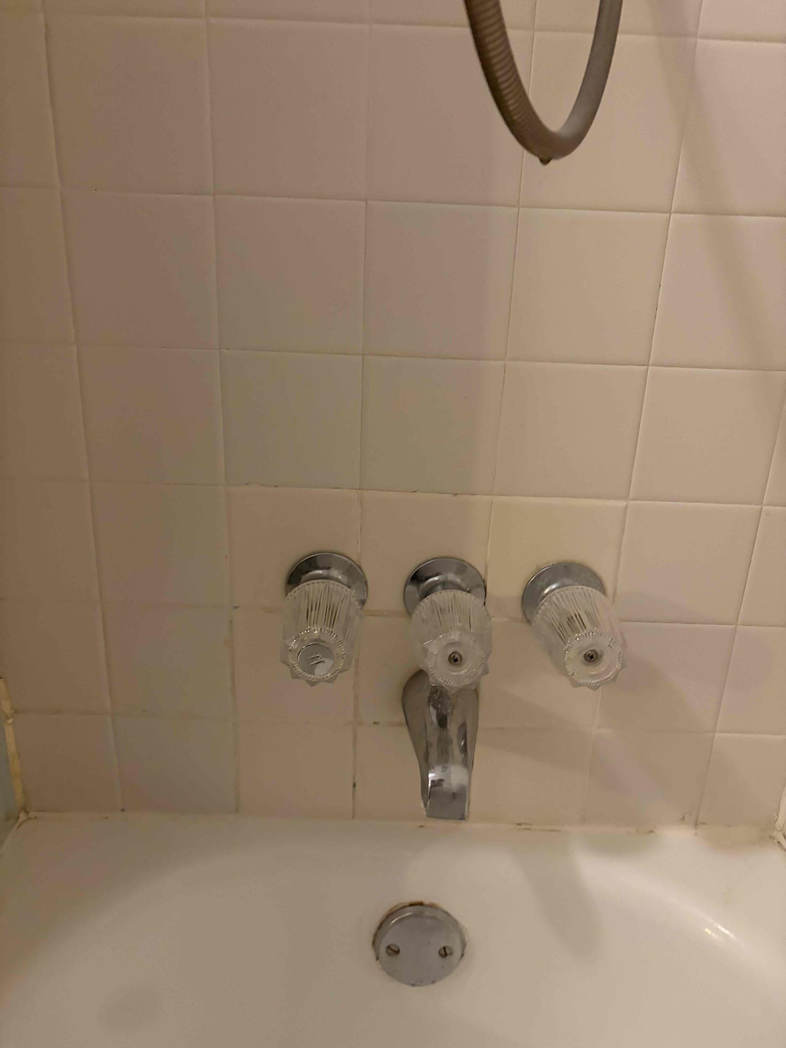 For this job, they have a three handle shower valve in both bathrooms upstairs the valves can be repaired however, we do not repair them anymore. We can only replace the three handle valves with a single handle valve to bring it up to code compliance. There are no access panels behind the walls due to the fact that the showers are both backed back in order for the proper replacements. We will have to cut a 4 x 5 square-foot section of tile to remove and relocate the shower valve to a higher location and also install the valve properly. We would have to convert from a three handle to a single handle and gave the customer a couple different options of what we can do the customer is wanting to find a tile contractor before proceeding with the work just so that they would have one on standby for when it comes time to install the new tile so they can use their shower. Water pressure is fine at 50 psi, additionally the water heater is still from 2007. It looks like they got it fixed by handy