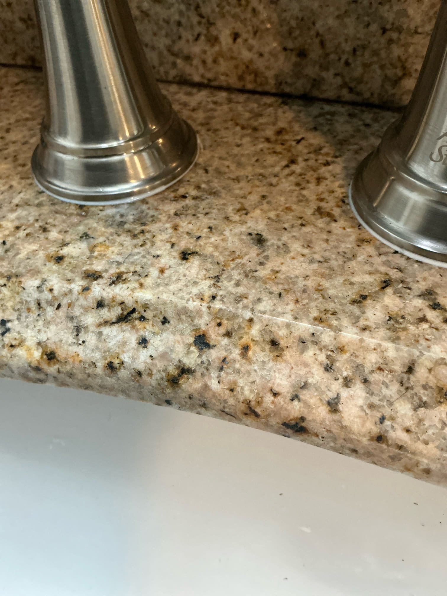 Faucet was leaking from handles due to water making its way underneath handle gasket applied caulk around handle to prevent water from seeping through. If this is not fixed problem, we have to reinstall faucet.