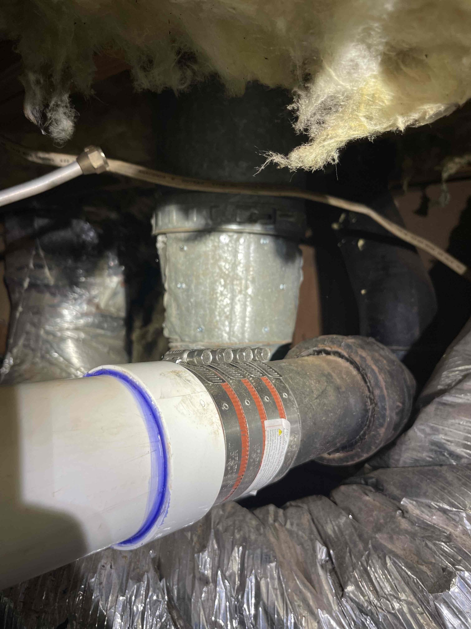 Came out for water coming up through the neighbors driveway and a toilet running. We shut off the main valve inside the crawlspace and isolated the water service and confirmed there was no leak. We then shut off all fixtures inside the home with the valve open and confirmed at the meter that there is no water running inside the home. The customer had a toilet that was running nonstop due to a bad fill valve that was flooding the drain field and it was showing up in the neighbors driveway. upon shutting the valve to the toilet and leaving for one hour to get materials, we returned and found that the leak had slowed a lot, and overtime did stop completely confirming that it was coming from the drain field. 

While we were doing our diagnostic in the crawlspace, we found that the cast iron line to the kitchen, had a hole in the bottom of the drain and was leaking sewage into the crawlspace. We also found that the gas water heater in the crawlspace, had a downhill pitch on the venting syst