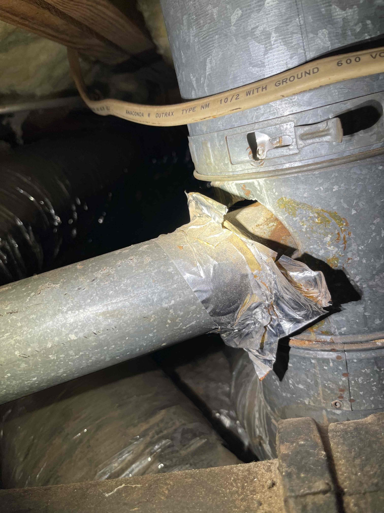 Came out for water coming up through the neighbors driveway and a toilet running. We shut off the main valve inside the crawlspace and isolated the water service and confirmed there was no leak. We then shut off all fixtures inside the home with the valve open and confirmed at the meter that there is no water running inside the home. The customer had a toilet that was running nonstop due to a bad fill valve that was flooding the drain field and it was showing up in the neighbors driveway. upon shutting the valve to the toilet and leaving for one hour to get materials, we returned and found that the leak had slowed a lot, and overtime did stop completely confirming that it was coming from the drain field. 

While we were doing our diagnostic in the crawlspace, we found that the cast iron line to the kitchen, had a hole in the bottom of the drain and was leaking sewage into the crawlspace. We also found that the gas water heater in the crawlspace, had a downhill pitch on the venting syst