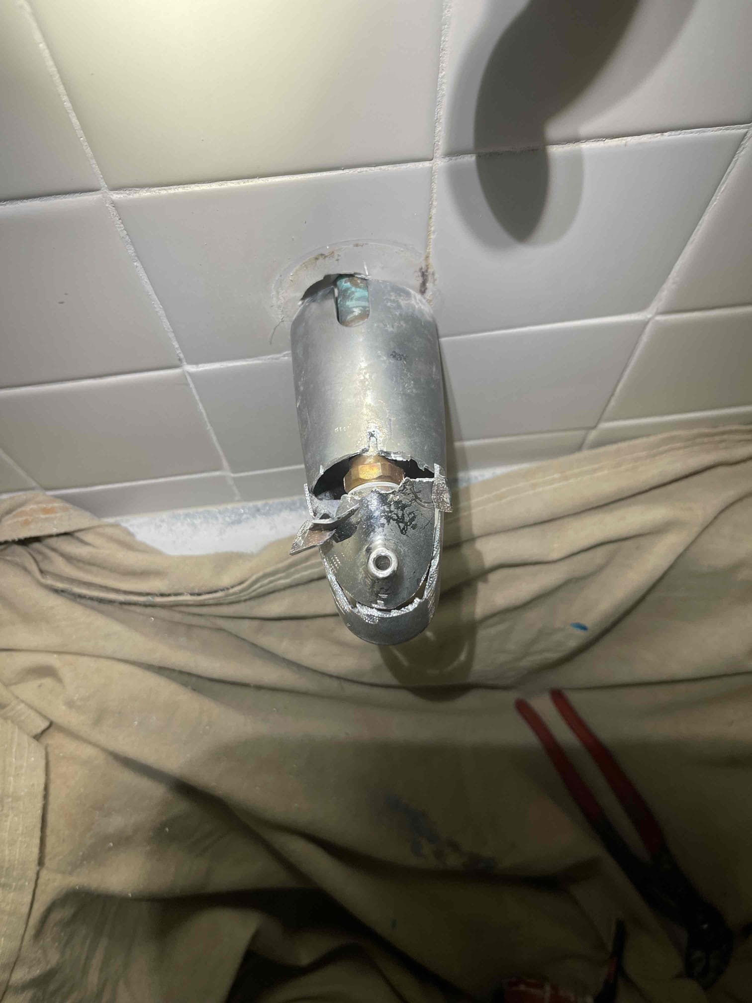 Customer had an old tub spout with an old sized diverter. She wanted to just replace the tub spout and gave us approval. Pipe inside the wall was very loose so we elected to cut the old one off so that we could hold the pipe steady with a wrench while twisting the tub spout off. Put plumbers putty in the tile penetration. Installed diverter and tested to ensure proper function. No further issue at this time. 