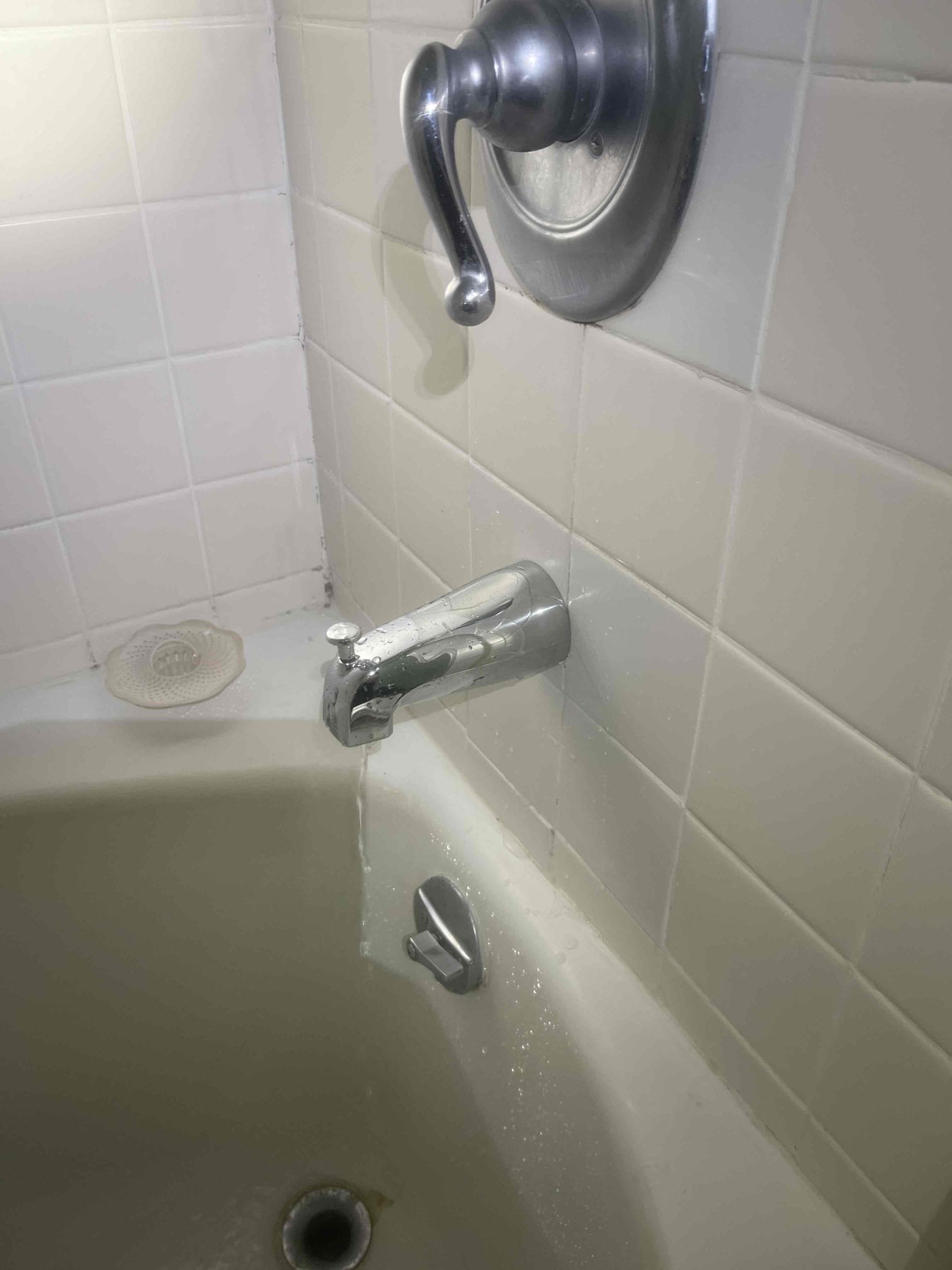 Customer had an old tub spout with an old sized diverter. She wanted to just replace the tub spout and gave us approval. Pipe inside the wall was very loose so we elected to cut the old one off so that we could hold the pipe steady with a wrench while twisting the tub spout off. Put plumbers putty in the tile penetration. Installed diverter and tested to ensure proper function. No further issue at this time. 