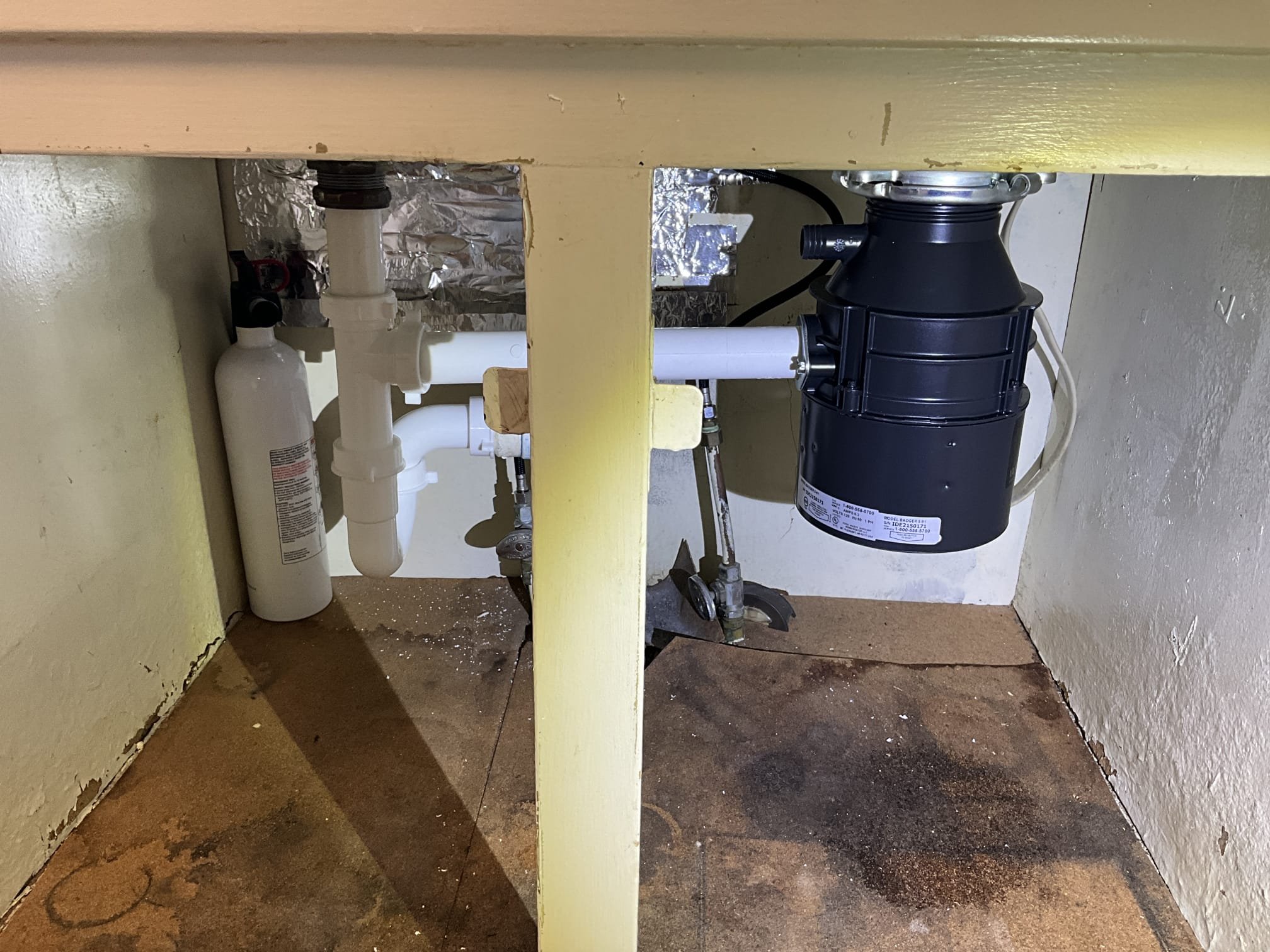 Customer had a garbage disposal that was leaking. Noted to customer that an S trap was present below the sink and doesn’t meet code requirements for the drain. During safety check found that there was two water heaters in parallel. An electric heater for 1999 and a gas water heater from 2023. Recommendations for customer is to replace the garbage disposal, install proper venting for the kitchen drain, and remove the water heater that is 27 years old. The house is a 3 bath house and 50 gallons heater via a gas water heater is sufficient for the home. Customer approved all work but not the membership. Replaced the garbage disposal and install an air admittance valve. Removed the electric heater in the basement and capped the old lines. Made customer aware that the electric heater didn’t have a dedicated breaker. It was labeled under the two pole breaker for the furnace in the box. Recommended customer have electrician remove the water heater electrical line and install proper wire protec