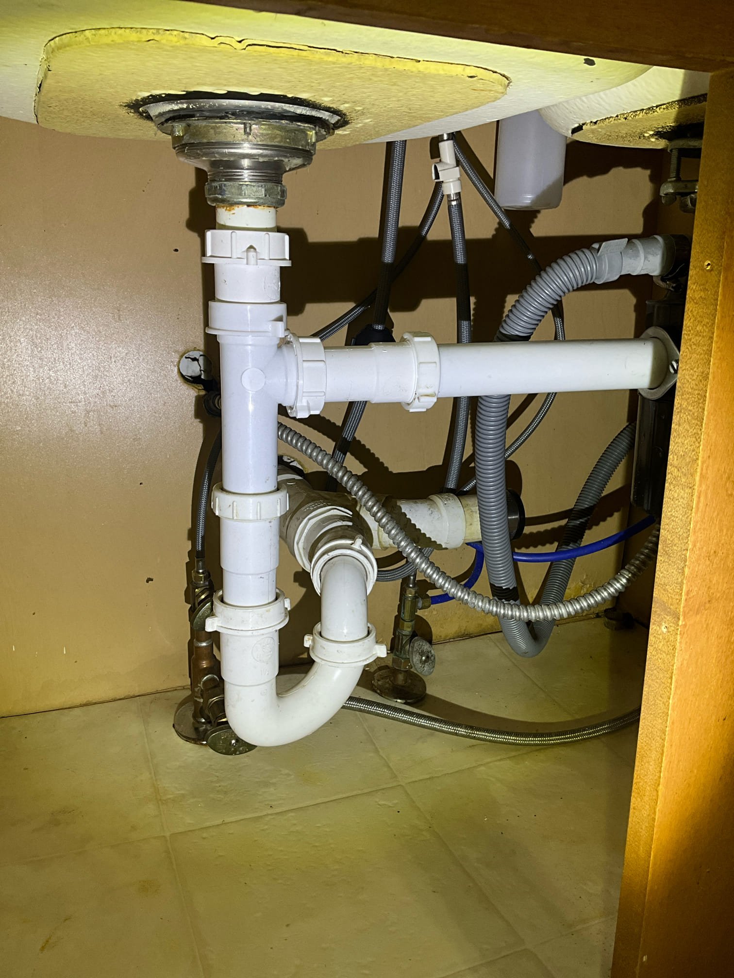 Customer had a leak from unknown source under kitchen sink. Determined that an abandoned and uncapped p trap for the old dishwasher connection. Gave customer price to tighten kitchen faucets and cap the trap. Added extension tube for incorrectly cut tubular that wasn’t connected securely. Made customer aware that this courtesy tubular repair is neither a charge nor warrantied. Customer understood. Left price for a new water heater and basket strainer. Existing basket strainer isn’t tightened properly and has a lot of silicone preventing it from being tightened. Told customer we would install the basket strainer as a courtesy if done with the water heater. 