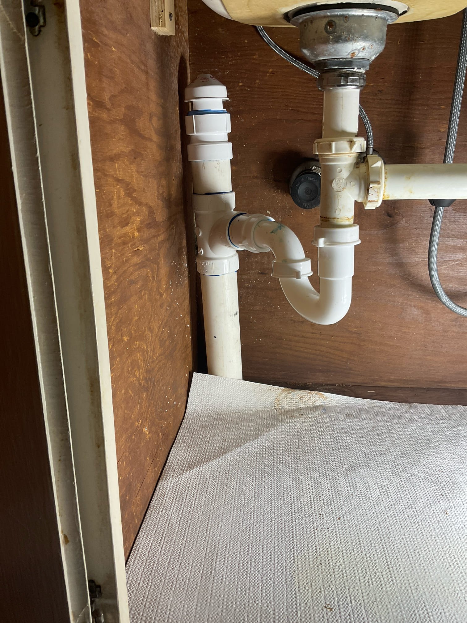 Leak under the kitchen sink at old lead pipe , we bypass the old pipe l ran new pipe thru floor and reconnected to the pvc pipe in crawl space , new p trap and AAV installed . 
