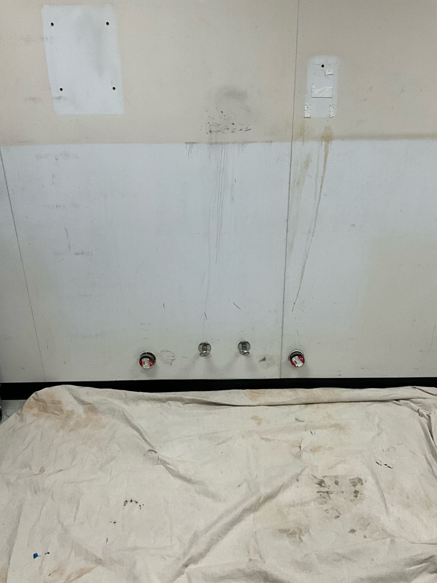 Return to complete quoted work.

Met with Nate on site and received go ahead to shut water off to right side of building.

Shut down water, drained system. Cut vinyl or pvc type wall cover, and drywall behind it. After water was drained I cut back waterlines and drain lines and capped each. After bringing water back on and checking for leaks I put drywall back over hole, secured with screws where possible. I then applied the vinyl type cover and applied silicone around seams. Bled all fixtures in this zone to prevent water splashing during use. Water back on without disruption to scheduled OR time.

For gas work, I removed leaking component and reinstalled correctly. After verify the leak was corrected, I sanded rusted components and applied protective paint, as required. Due to weather I had to do each gas assembly one at a time to avoid water getting on paint while it was curing. After all work, both gas assemblies have had rusted components sanded, and paint has been applied to all 