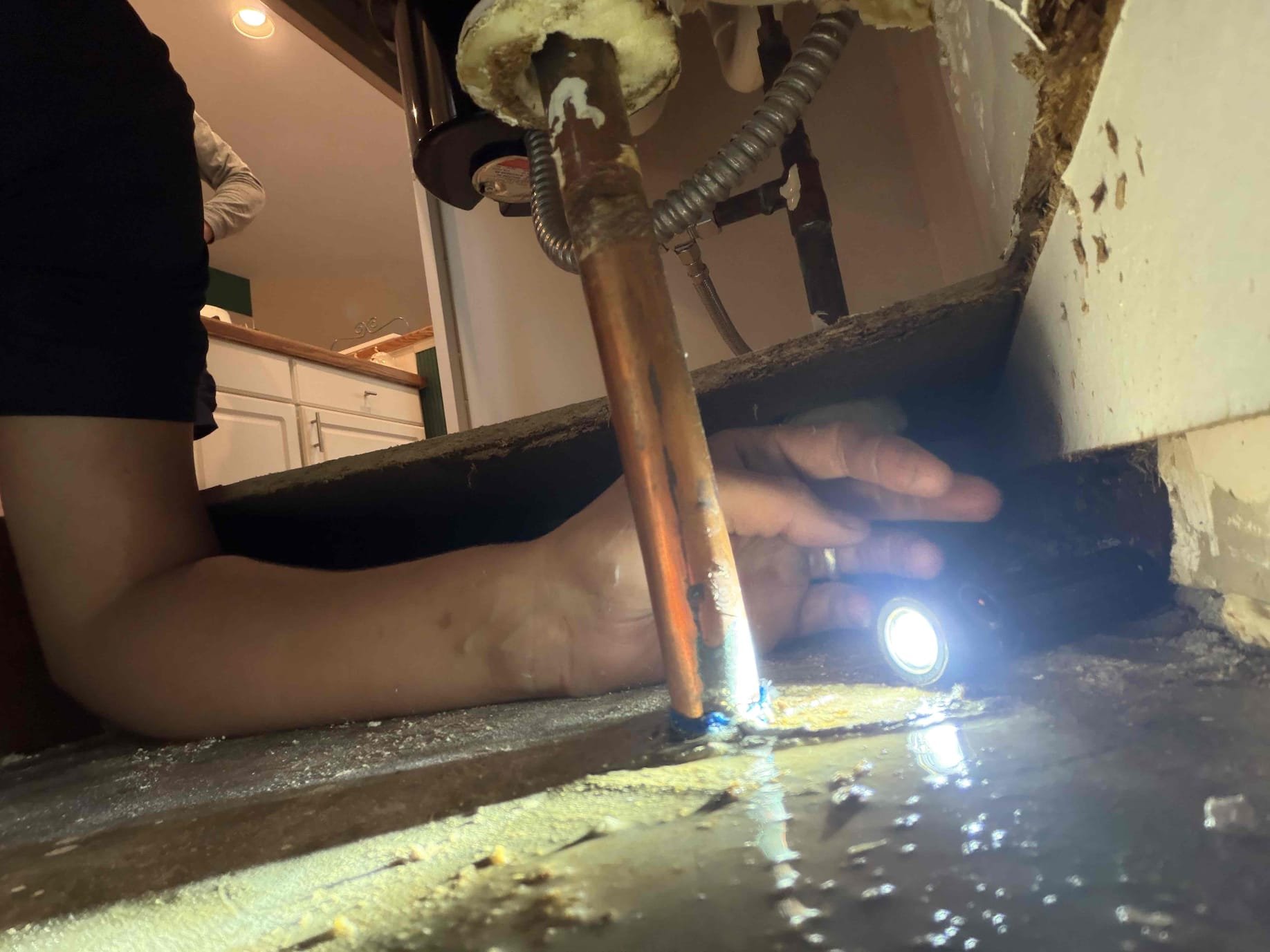 For this customer, they have a leak on the cold waterline right up against the slab in the copper pipe, in order to properly fix the copper piping. We will have to remove concrete by chipping it out and jackhammering the floor in order to properly repair. The section of copper piping is a very small hole, but it created a lot of damage. I have referred to customers who are water restoration partner. In addition to that his water heater is from 1997, recommended replacement on that unit however the main priority is getting his water back onto the house. Give him a few options of what we could get started today however, the customer wants to shop around and get different estimates for this type of repair I had drawn a sharpie of where I would start my cut into the slab. For the proper fix. The customer wanted to just put a bit of solder on the hole to see if that would fix the solution. However, I had mentioned to the customer that we do not do temporary or Band-Aid repairs and that woul