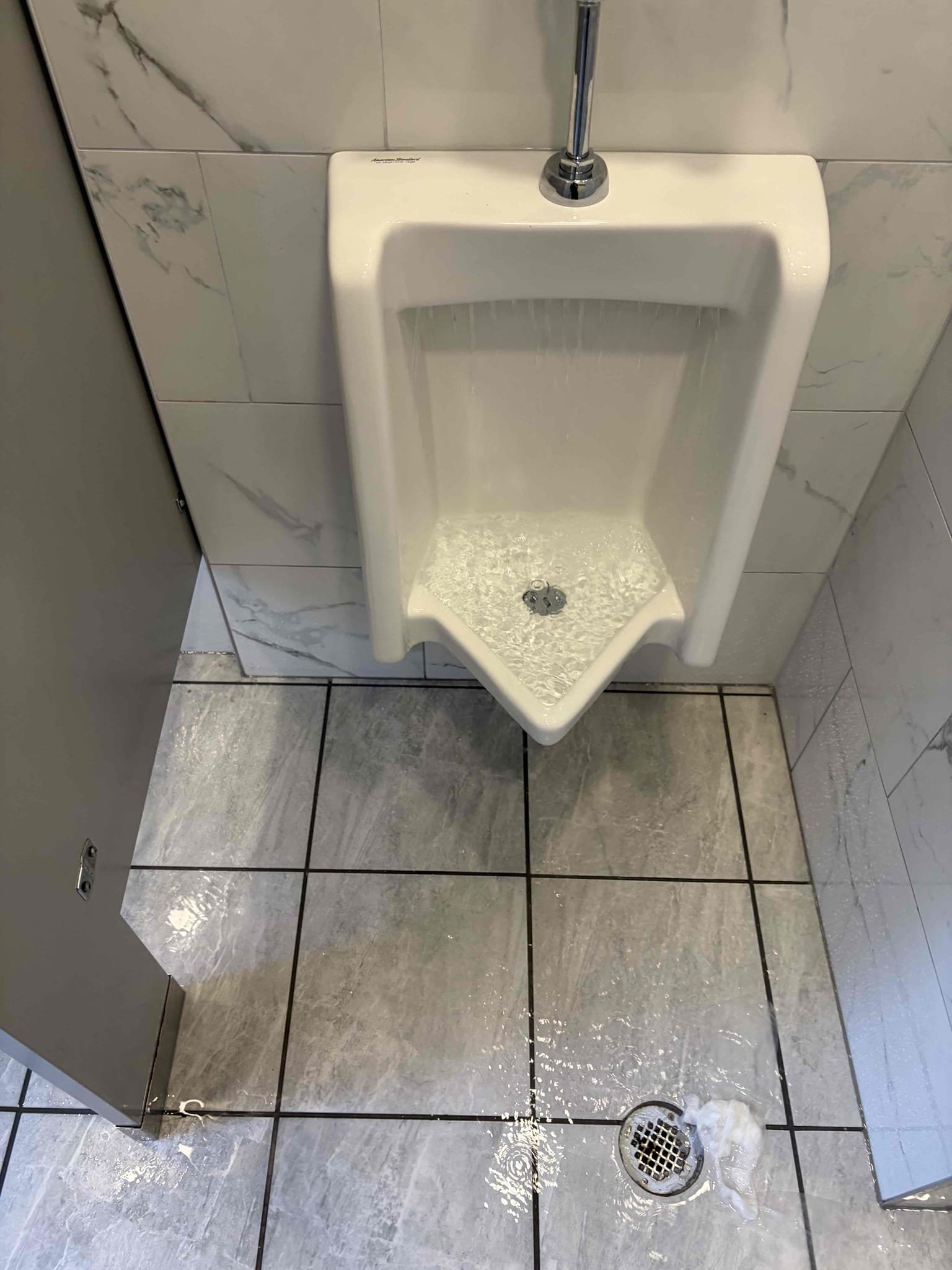 Replace urinal flushometer in men’s restroom 
Auger toilet 

Came out to this commercial property due to a leak coming from the urinal, the urinal was constantly flushing and the toilet was clogged. I used my 6 foot auger to get the toilet unclogged and the toilet is flushing again, I can see the water coming out the clean out outside, additionally we went ahead with the urinal flushometer replacement. Installed a new Sloan 0.5 flushometer 186. I replaced it with a new vacuum breaker and new head unit. Once installed there are no further leaks. Customer is all set at this time of service.
