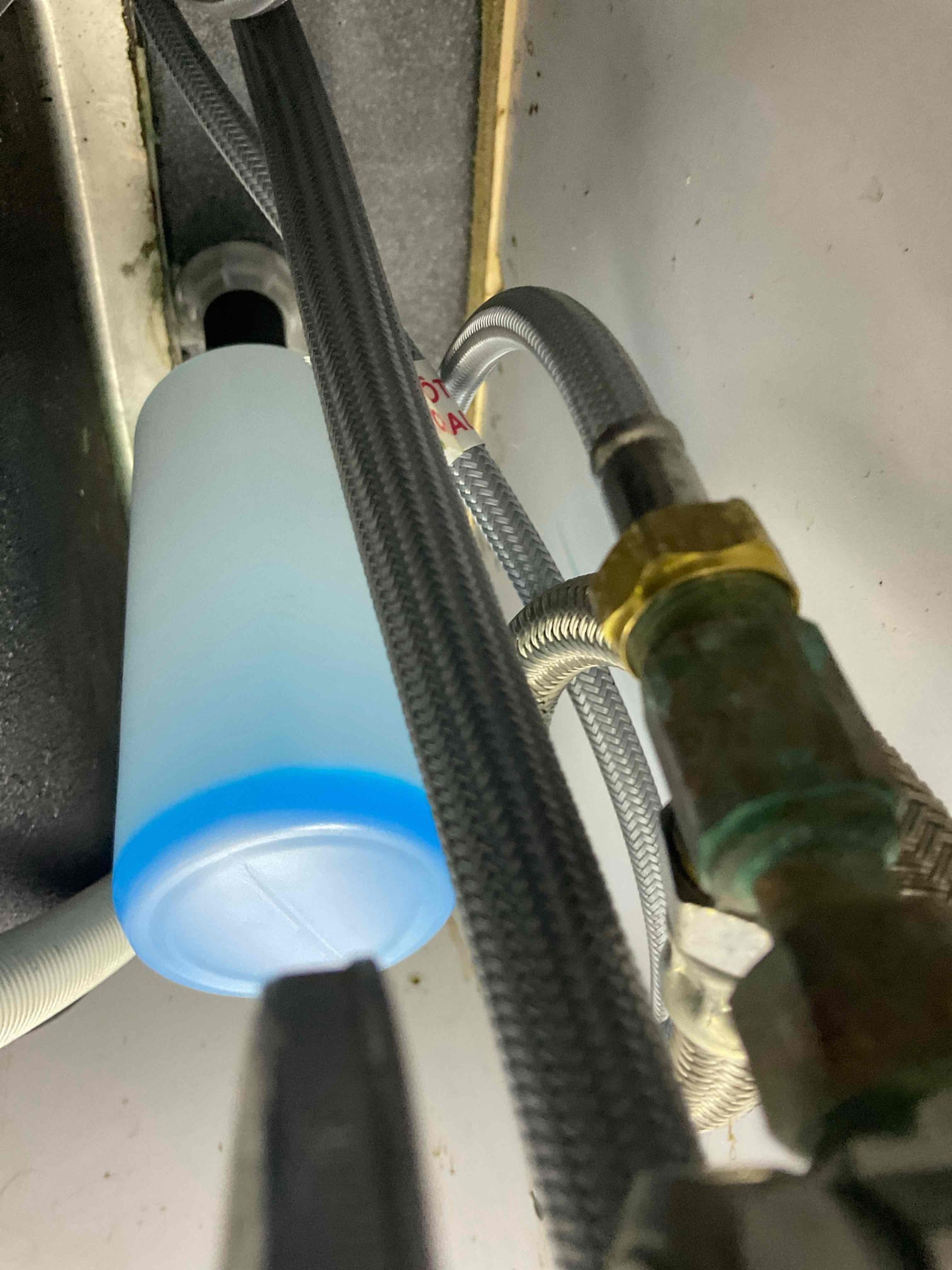 Fixed a small leak under the sink from soap dispenser area , removed a spacer and tightened nut with some clear caulk under the soap dispenser flange , warranty work , no charge 
