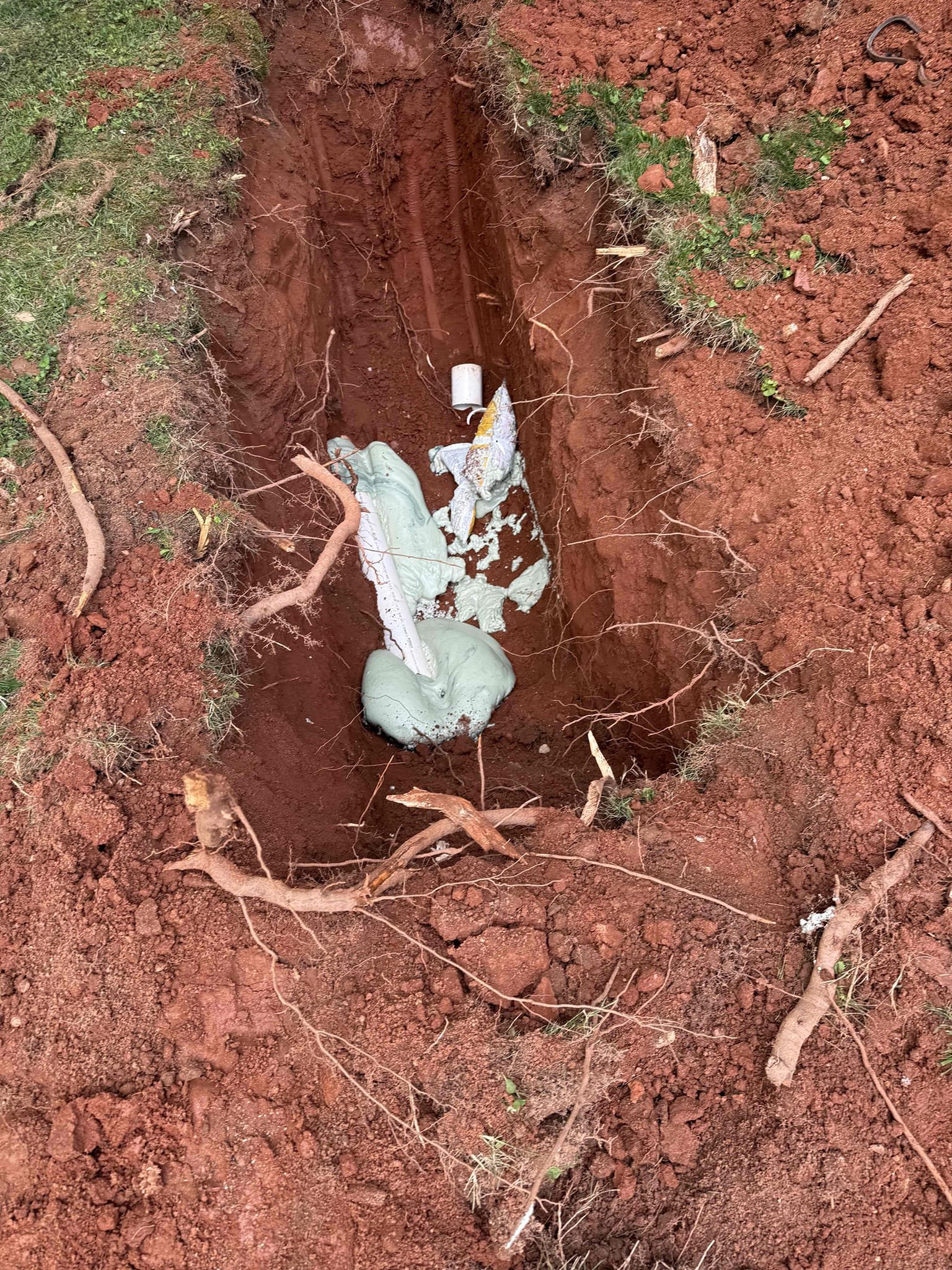 Upon arrival customer wanted a quote on on main sewer line spot repair in front yard, replacing about 60 ft of cast iron from kitchen sink and laundry drain, and replacing expansion tank and removing all shark bite fitting from hot and cold lines. Customer approved quote, removed all cast iron from kitchen sink and washer drain leaving the cast iron p trap because customer did not want us opening up the wall, we by passed the old vent for the kitchen sink and stubbed down through kitchen cabinet 2 in pvc adding a new p trap and AAV and capping the old vent in crawl space and in kitchen cabinet. We replaced about 6 ft of 4 in pvc in the front yard of the main sewer line that failed due to roots. Removed old expansion tank and all shark bite fittings and replaced the expansion tank and added a bracket mounting it on the wall. Tested for leaks everything is working properly no leaks upon departure.