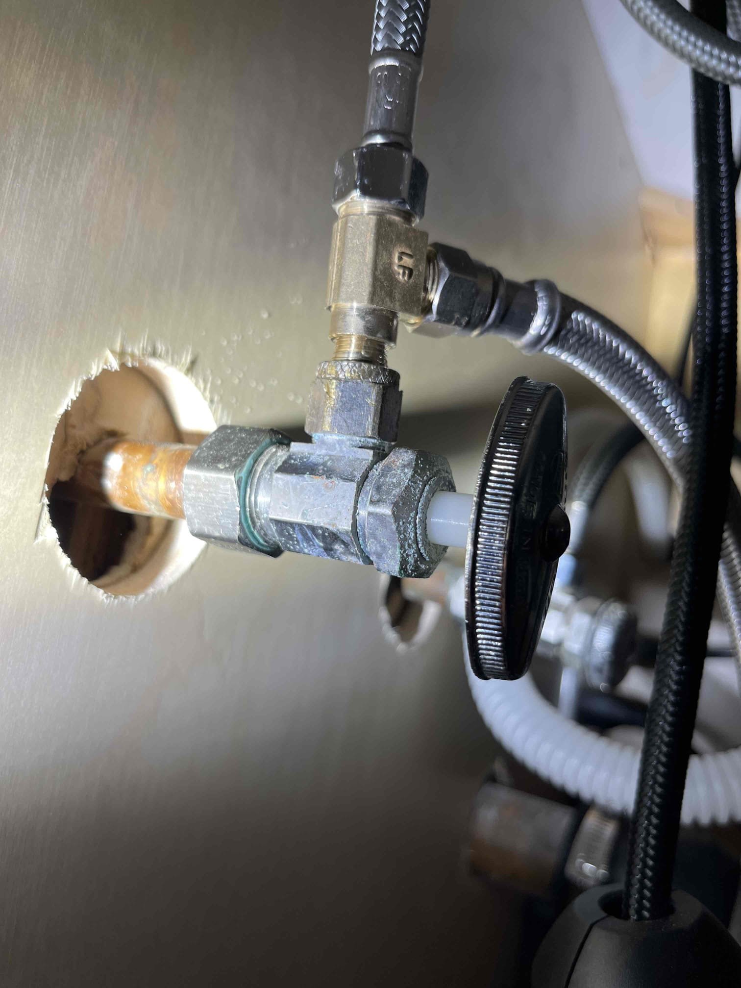 Homeowner recently had his kitchen remodeled. They used a threaded tee connection on the hot side of the sink to split the line. One of the threaded connection had no gasket or sealant on it and was slowly dripping. I sealed the threads and reinstalled it. Confirmed no leak after sitting pressurized for a few minutes. Left quote to replace the kitchen drain line as it has rusted nodules in multiple locations. 