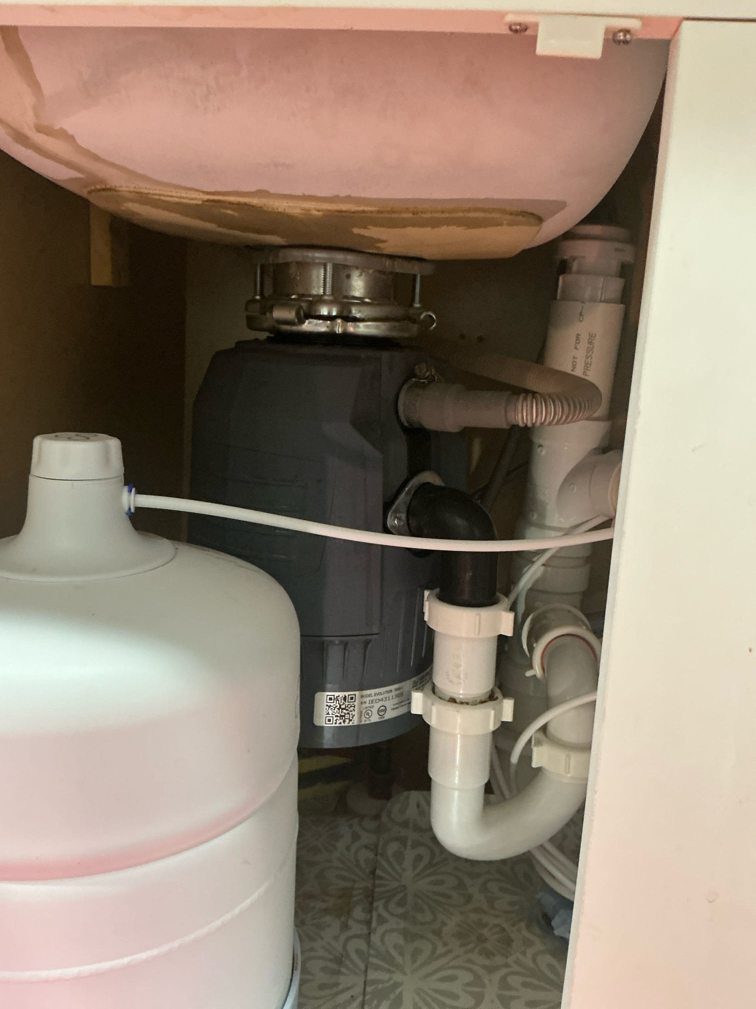 Disassemble disposal that was recently installed. Reset the collar and tighter properly. Reinstall disposal and reconnect all drain piping. Test for proper operation and leaks. Clean work space.