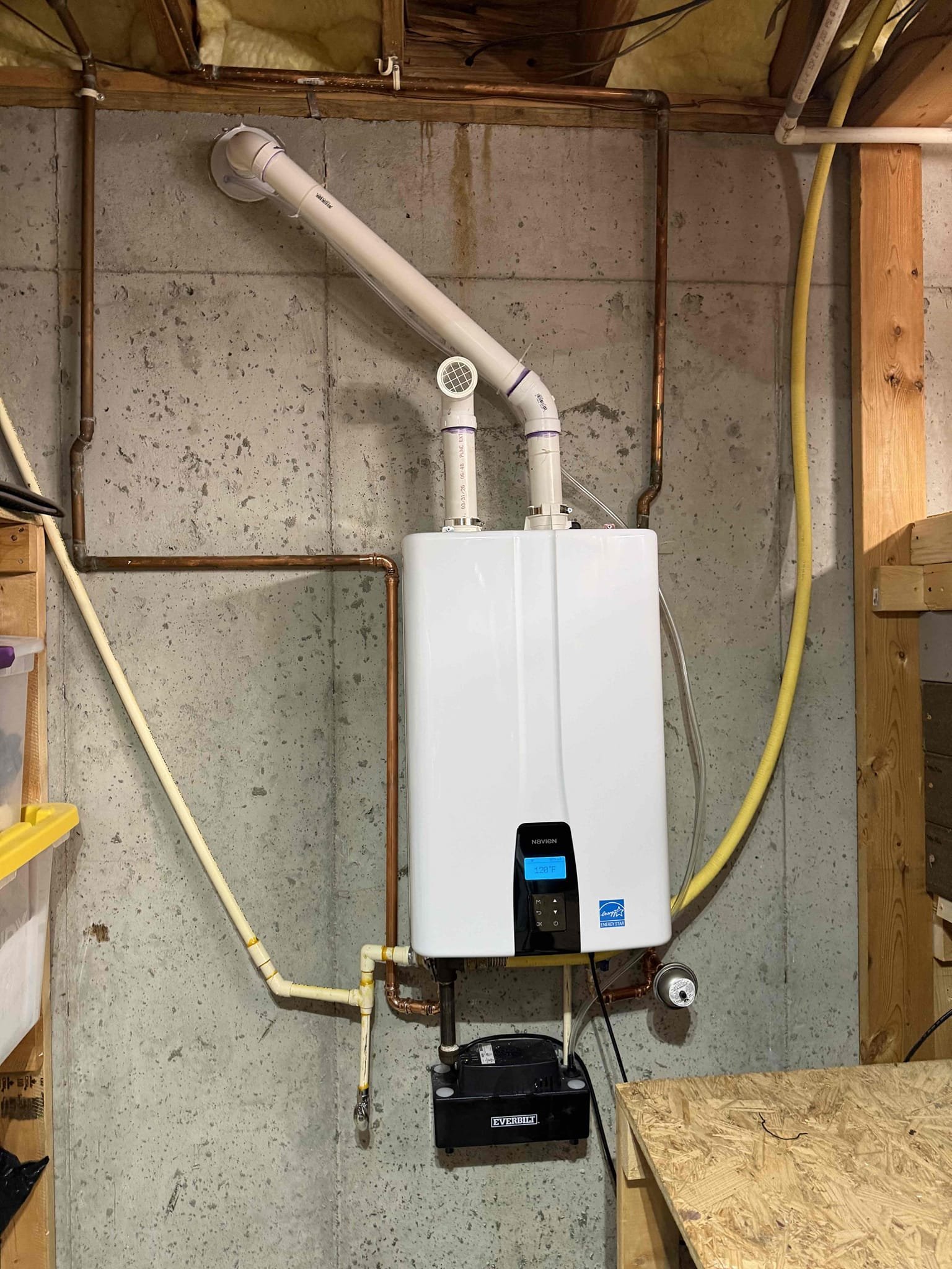 Returned to swap rinnai tankless for a navien 240a2. Installed new navien 240a2 with new service ports, new expansion tank, and added a condensate pump to pump the condensation outside of the home. Ran new 2 inch pvc vent and sealed up the wall with hydraulic cement. Ran caulk around the pipe as well to ensure no water can come back in. Turned water on and fired up tankless to check for leaks, found no leaks. Made sure tankless was producing hot water and condensate pump was working properly. Customer now has hot water and tankless is working properly upon departure.
