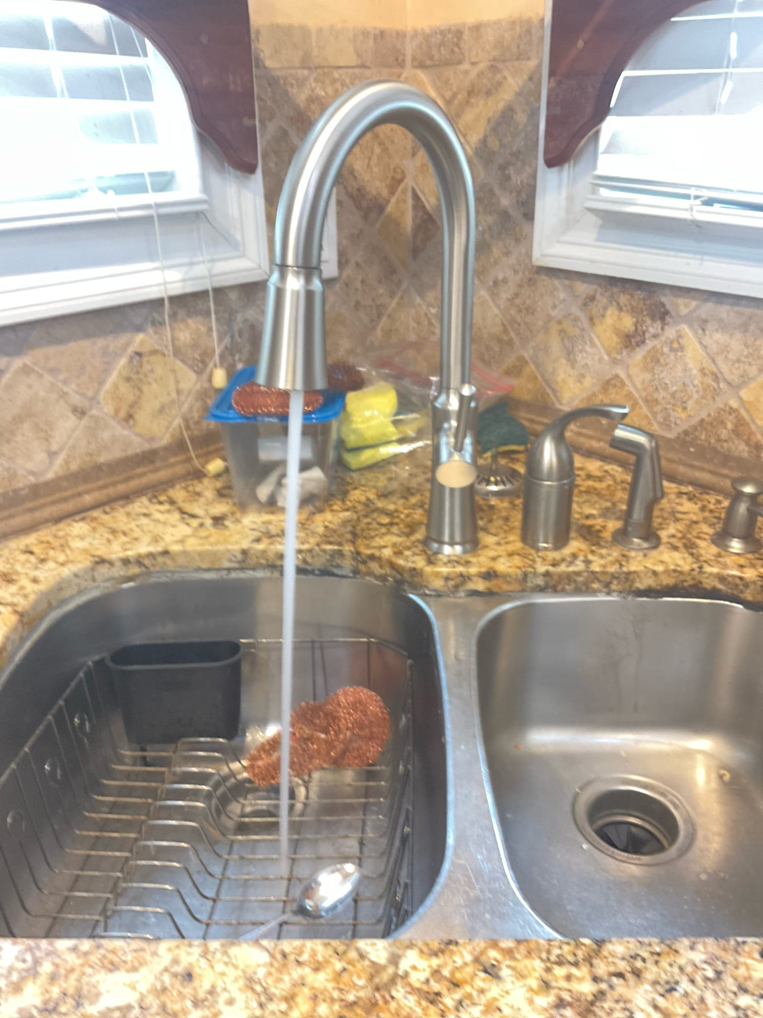 Arrived today with water off for the kitchen faucet , customer bought a new replacement faucet , explained to the customer new faucet only use one hole , old faucet has three holes , we have to use sink hole covers to cover extra holes with some additional charge , customer decide just keep the old faucet handle and spray hose and old soap dispenser as for not left hole open and paying extra , faucet is installed with handle on the Front instead on side as normally because is too close to the old faucet handle since we did not remove it , this is approved by customer. 
Also cabinet door hinge was very old and loose , disposal looks about to leak , customer just told me replace it later 