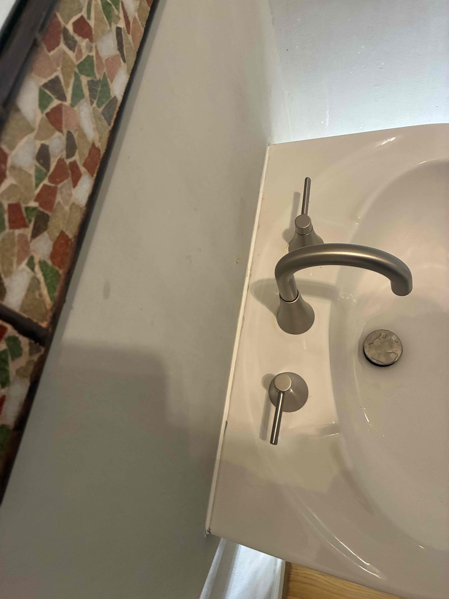 customer had widespread faucet on pedestal sink needing replacement. Offered full plumbing inspection. And checked pressure of house. Customer wanted to address faucet. Gave options for replacement installed new customer provided faucet with pop-up as assembly. Set pedestal sink back on wall caulked to wall. Ran water to check for leaks and proper function.