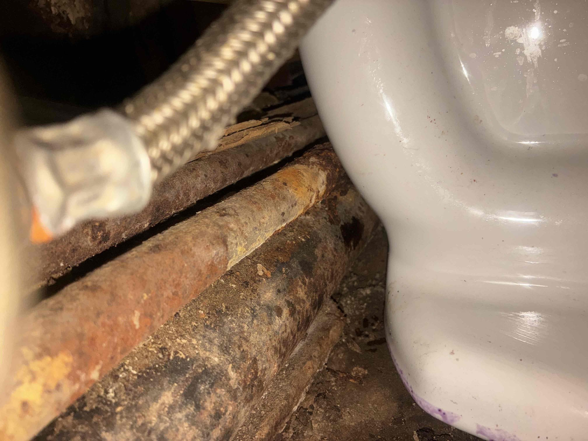 Customer stated water coming from toilet bowl and below toilet. When I arrived, no water was present. Ran water in order to attempt to re-create issue. Was unable to do so. Gave options for camera. Pulled toilet, ran camera all the way to manhole. Pulled manhole and found brick/rock debris. Removed debris and flushed system. Had to cut three-quarter old black iron pipe out from behind toilet in order to have toilet sit more properly. Explain to customer about conditions of toilet. Set toilet back and flush to check for leaks and proper function.