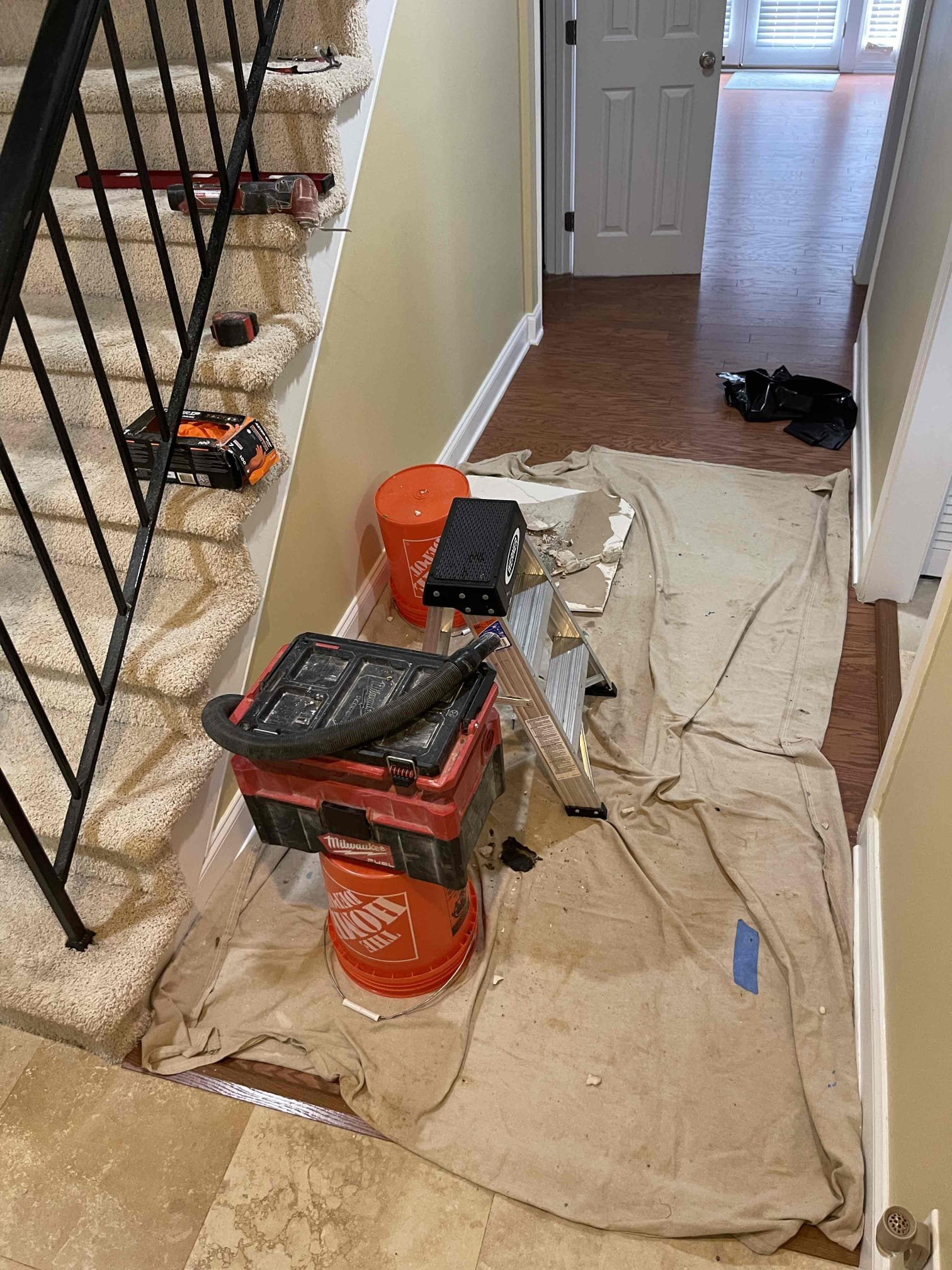 Came out for a leak in the ceiling. Arrived and met with homeowner. He directed me to the ceiling right in front of the front door. Signs of old water stains in the ceiling on the drywall. Customer said they had a back up in the past on that bathroom and had the blockage cleared and the toilet pulled and reset 1 year prior. Customer elected to open the ceiling so we could inspect for the source of the leak. After opening the ceiling we confirmed that the leak was coming from the seal on the bottom of the toilet by flushing toilet several times. We pulled the toilet and found the flange was sitting below the tile and the wax gasket was not touching the toilet. We had to resort to installing an extra thick wax ring to form a proper seal as we are unable to replace the flange without significant cast iron replacement in the ceiling due to the homes builders use a lead bend of the flange with a very short sweep that will not allow modern pvc sittings to fit inside the same amount of space.