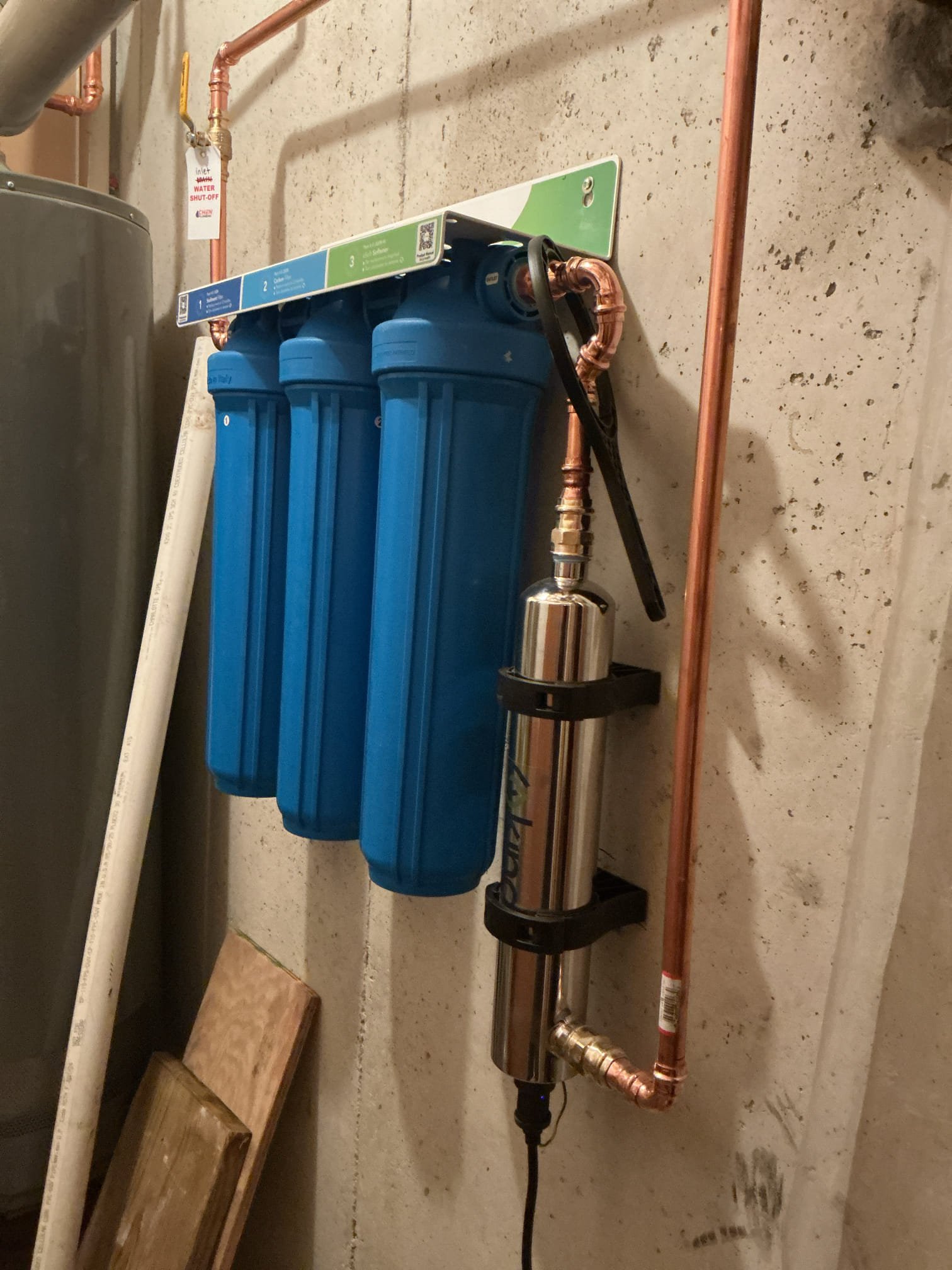 Returning to install customer supplied whole home filtration system. Installed filtration system with UV light add on. Secured mounting bracket to concrete wall, then secured housing to bracket for filters. Also mounted UV light to wall. Properly valved area of work with tags for explanation of valves. While running water to flush filtration system after install found sewage ejection pump for downstairs basement to not be working properly suggested to replace pump due to malfunction and age removed old pump and installed new zoller sewage ejection pump after pump install ran water to check for leaks and proper function