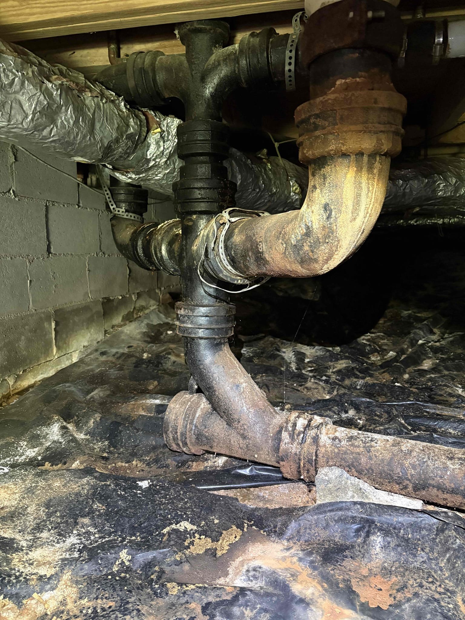 Diagnosed smell from kitchen and laundry area. Did not smell anything upon arrival. Checked crawlspace and found leak on drain line from kitchen. Smell is from standing water in crawlspace and coming up. Left estimate to replace cast iron drain lines in crawlspace. Upon further inspection noticed pressure is on lower side at 48 psi and found main line to be galvanized. Noticed heater is 9 years of age and not up to code. left estimate for galvanized water service replacement and water heater replacement with code upgrades 
