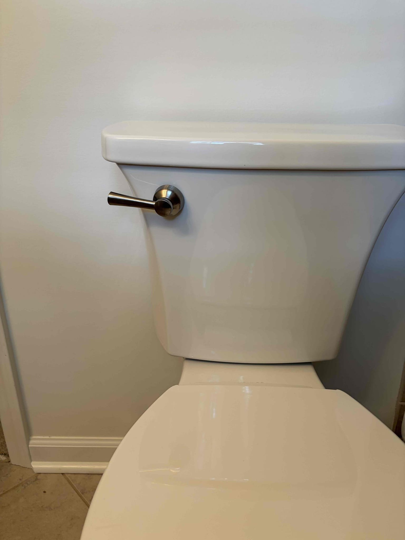 Install customer supplied toilet upstairs 
With a new handle brushed nickel 

For this customer, we came out to a toilet that would leak when flushed from the back of the toilet between the tank in the bowl. There had been multiple cracks on the toilet itself on the tank, some hairline cracks, which could be indicating the problem. However, the customer decided to purchase their own toilet for us to install it the Toilet that the customer went with was the Kohler highline arc toilet round we got that toilet installed we scraped off all the old wax installed some new closet bolts. In addition to that once that new toilet was properly installed we caulked around the toilet, installed the tank to the bowl with all the supplied hardware from Kohler Installed a new 16 inch braided supply line as part of the installation. The shut off valve works perfectly fine and to add to that we installed a new brush, nickel corky style lever to match the rest of the bathroom once installed there are no 