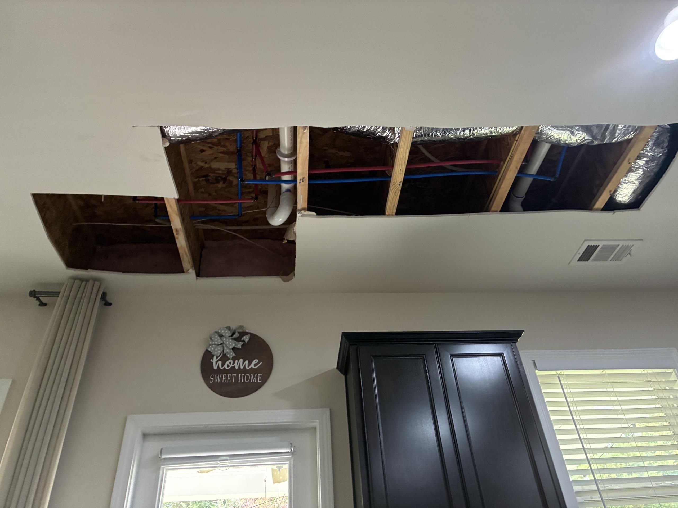 Return to perform Repipe of home to remove defective uponor piping.

This job spanned four days, and included following:
Cut drywall throughout home to access pipes and routing. This included in parents bedroom, bedroom behind master bathroom shower, throughout main level ceiling, behind washer and dryer, behind fridge, near water heater.

Some preexisting pipes were in the slab. Rerouting pipes above ground makes it impractical to route recirculating line to kitchen, as this sink was on an exterior facing wall, and isolated. However, it is only approximately 25 linear feet from water heater so there should be minimal change in delivery time. New recirculating line branches from line supplying all other bathrooms, returning from near master bathroom. 

Hose spigot moved from left side of house to behind kitchen to avoid cutting entire length of front room ceiling and wall. The new location is accessible and more centrally located for back yard work. Old hose Bibb is capped and left in 