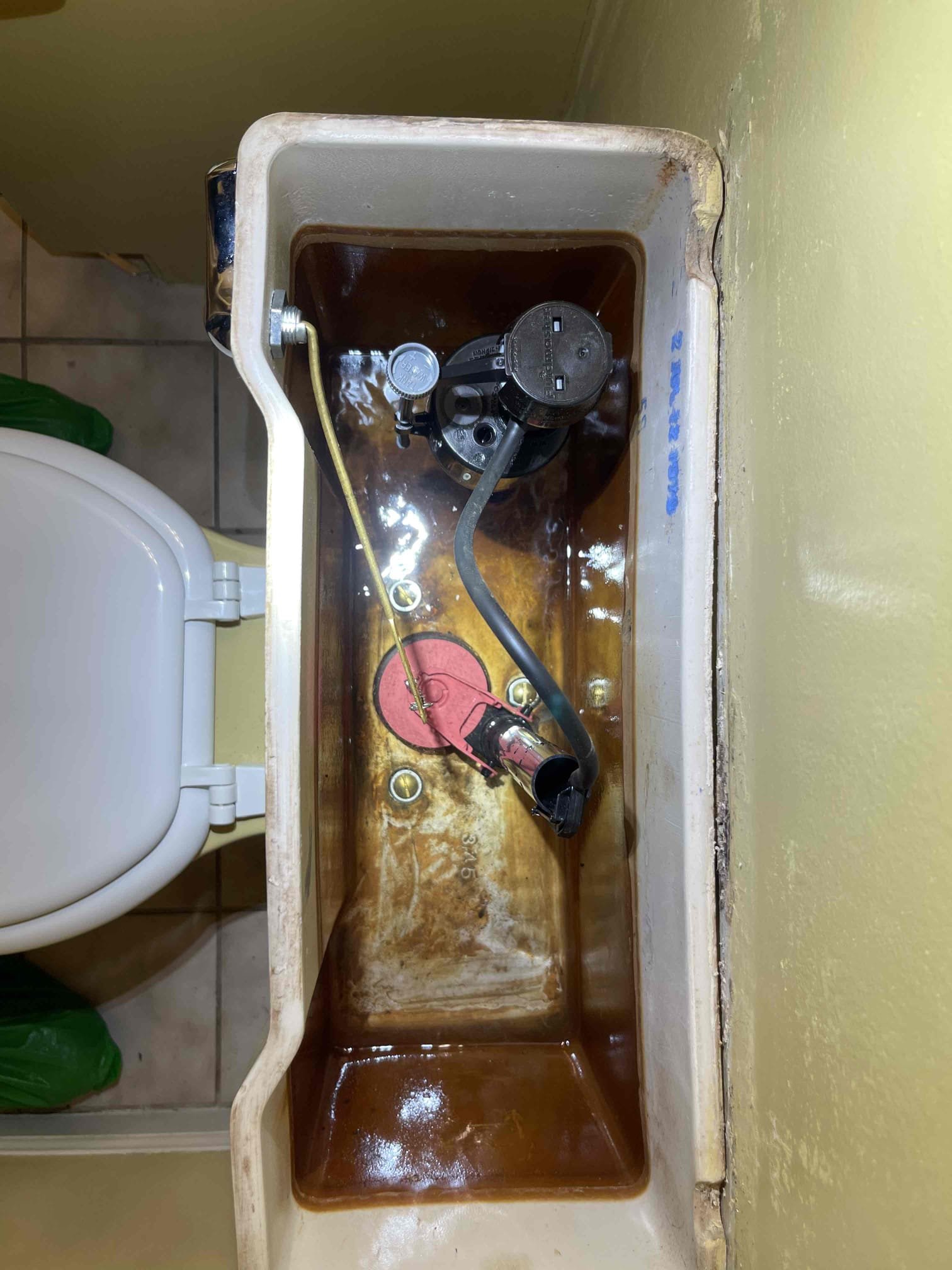 Came out for a toilet whistling. Arrived and met with the homeowner. She directed me to the hall bathroom toilet. When the toilet was flushed, the fill valve was making a loud whistling noise. Inspected inside of toilet and found the tank bolts were just piles of rust inside the tank. Told the homeowner I could replace the fill valve but recommended rebuilding the whole tank. Toilet would not be cost effective to replace as it is tiled into the bathroom floor and would be difficult to find a toilet that matched the size and shape. Valve to the toilet was very difficult to turn. Recommended that we replace the valve but the customer requested I spray WD40 on the valve which I did at no charge. Not responsible for any failures of the valve. Closed the main valve to the house and drained off the pressure to work on the tank. Swapped the fill valve, flush valve, 3 tank bolts, the toilet handle, and the supply line. Tested to ensure proper function and a leak free installation. No further i