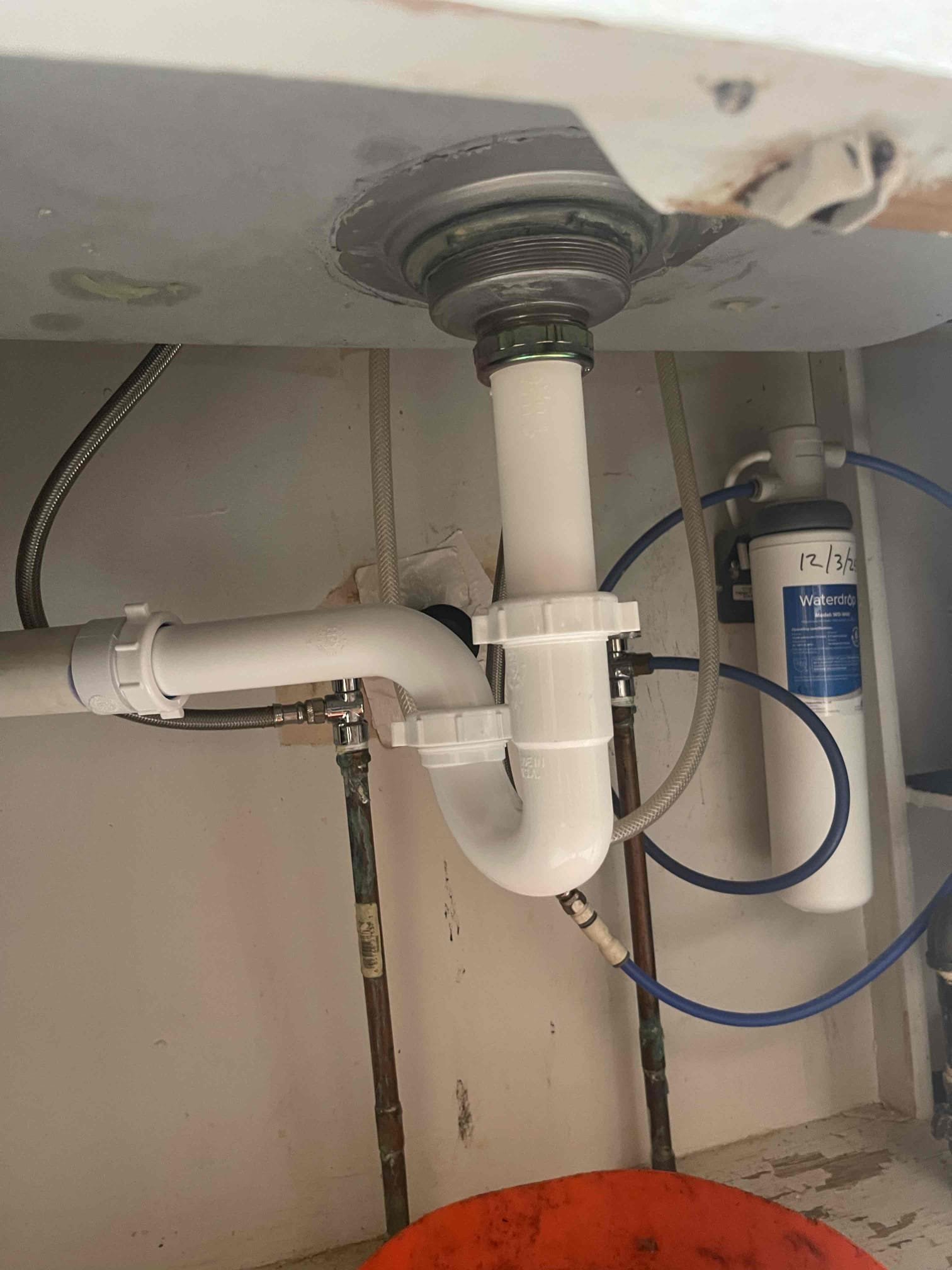 Came out to reassess why the kitchen sink was having trouble draining. Homeowner said it was very random, and the water would always eventually go down, but if they ran the water for long enough or dumped a pot of water in the sink it would be slow to drain. I could see through the tubular to verify the drain was not backing up at all. Realized the old style shallow basket strainer tee was sitting flat against the washer for the tubular tail piece, which had restricted the diameter of the basket strainer opening in half. Installed a new deep basket strainer and no longer had any issues with the water draining. 