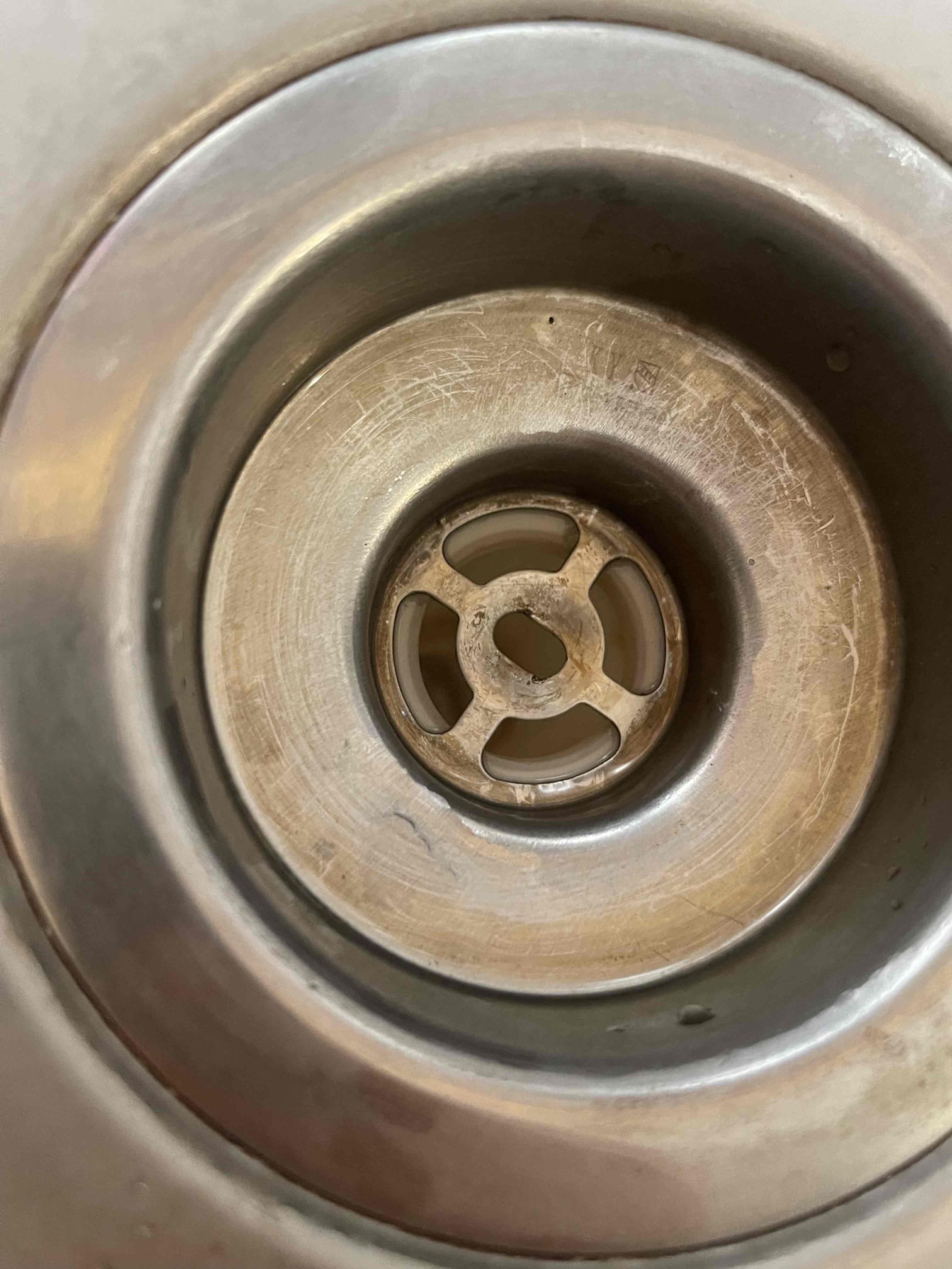 Came out to reassess why the kitchen sink was having trouble draining. Homeowner said it was very random, and the water would always eventually go down, but if they ran the water for long enough or dumped a pot of water in the sink it would be slow to drain. I could see through the tubular to verify the drain was not backing up at all. Realized the old style shallow basket strainer tee was sitting flat against the washer for the tubular tail piece, which had restricted the diameter of the basket strainer opening in half. Installed a new deep basket strainer and no longer had any issues with the water draining. 