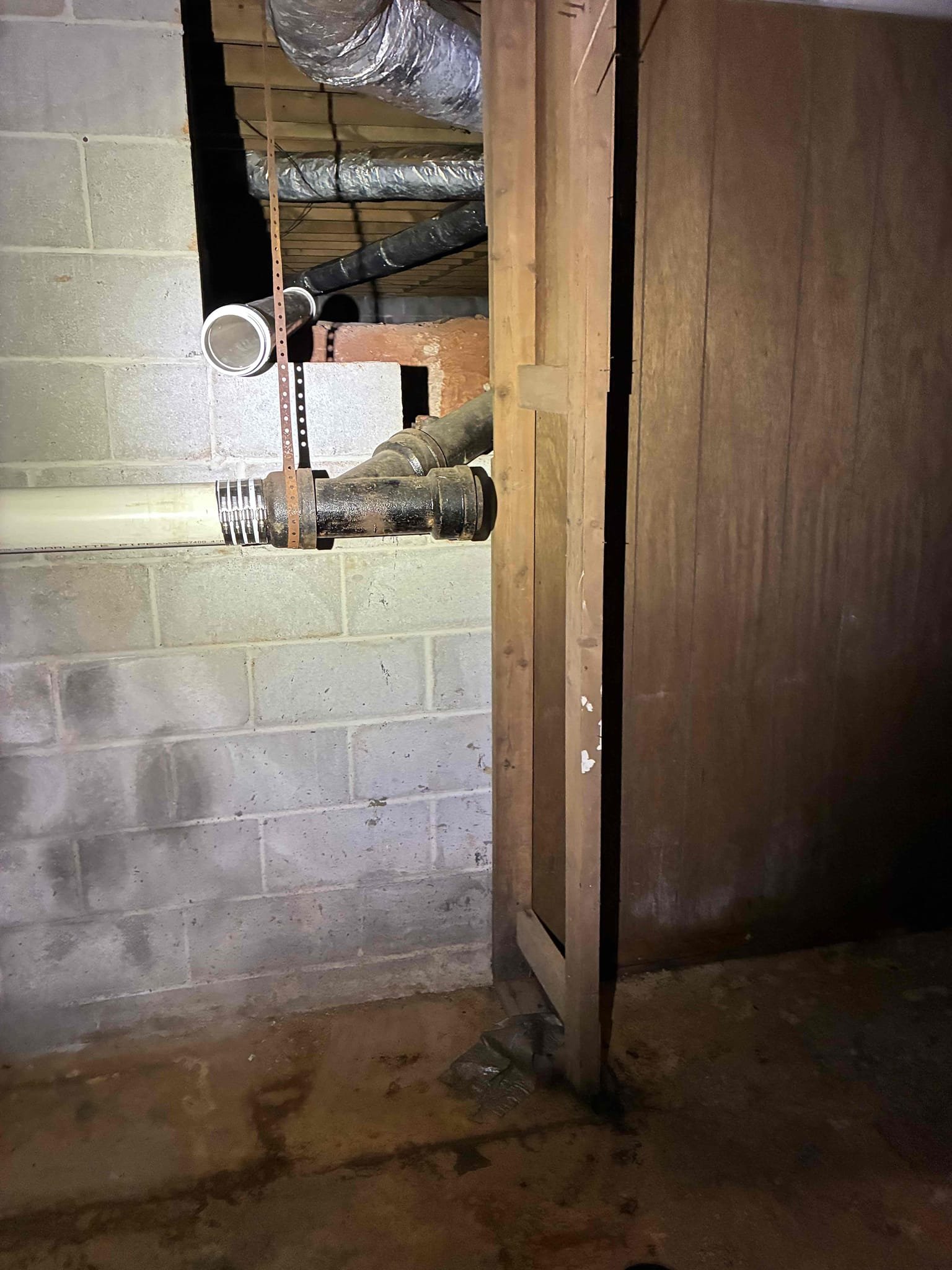 Found leak in crawl space on 4” cast iron pipe. System had blockage. Installed clean out to system on out side of house to right of porch. Jetted system to clear blockage. Cut out 5’ section of 4” cast iron pipe and connected new 4” pvc pipe. Filled tub and drained also ran water for ten minutes to test. No issue at this time. Cast iron is thinning at bottom recommend replacing cast iron system with new pvc. No warranty on cast iron.