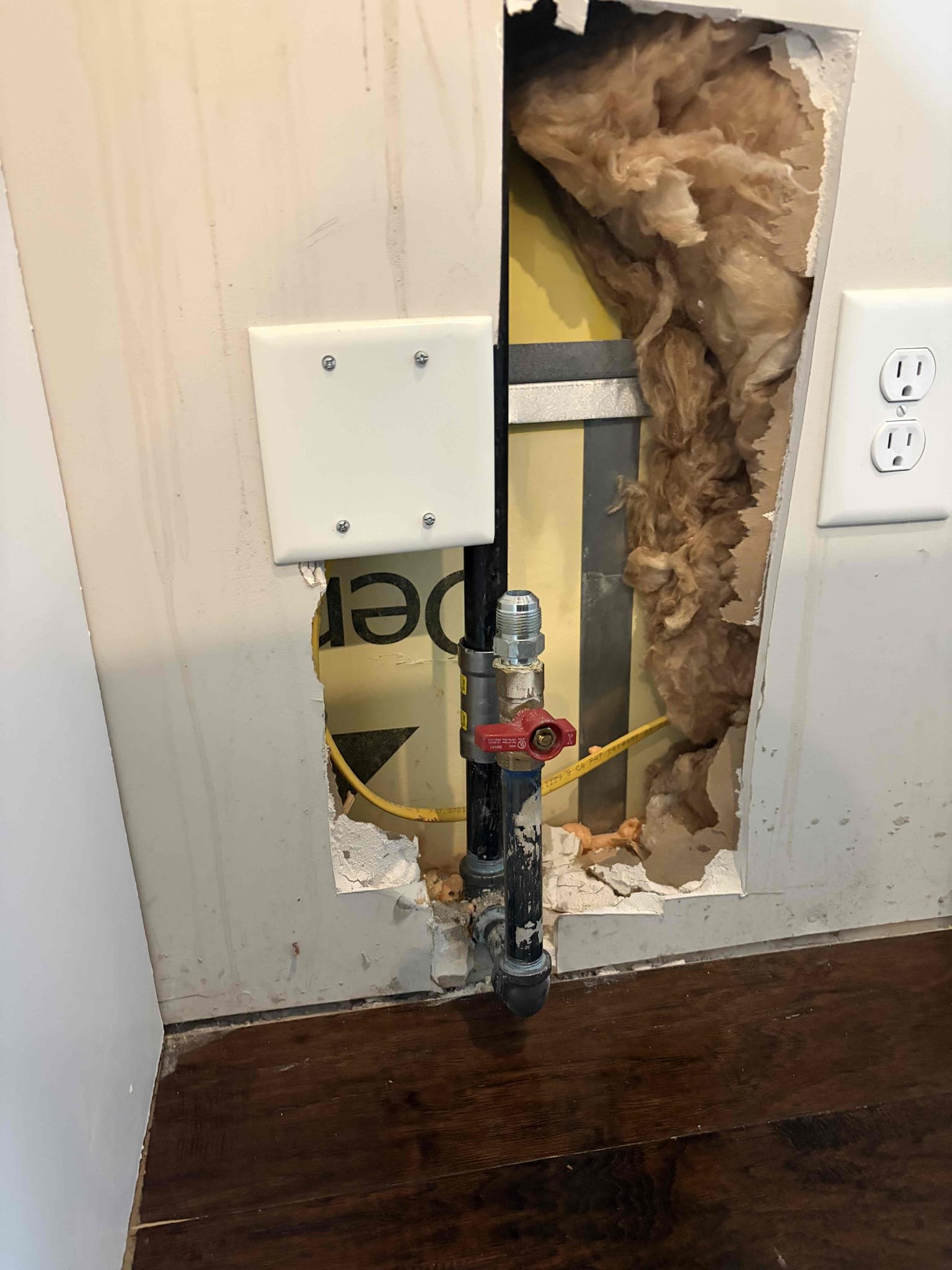 Repair 1/2 - 3/4 gas line behind range 
Cut drywall to access pipes

For this job, the customer called us out due to a leak behind the gas range. It was a gas leak, unsure of where it was coming from. However, I had detected that it was coming from one spot and I had disconnected everything that I saw it was a problem removed all the Teflon tape from the fittings however I went back with a new 3 inch nipple on a 3 inch 90 tight back together Pressurize the system and the meter was still going off along with the bubbles so I opened up the drywall to figure out where the second leak was coming from, and the second leak was coming from a three-quarter inch nipple however, this nipple went all the way up to the ceiling And went to the attic I assume so, therefore rather than twisting the nipple all the way up and cutting the drywall I recommended to mega press the connection so therefore cut the pipe too cleaned to burred the fitting. In mega pressed a slip coupling on to the pipe once it 