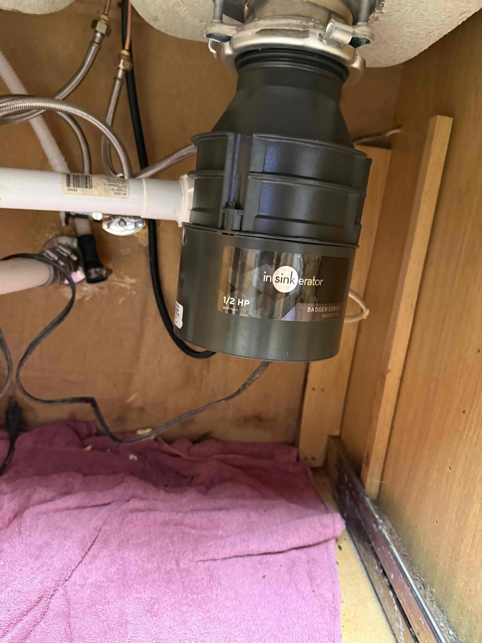 Upon arrival customer stated he noticed water by his cast iron pipes noticed two holes in the cast iron causing the water, kitchen faucet leaking, garbage disposal not working, and dishwasher supply line stubbed through floor not allowing him to install his dishwasher. Gave customer estimate to replace section of cast iron, install a new faucet, install a new 1/2 HP garbage disposal, and tee off of the hot line from kitchen sink to dishwasher and cap old line in the crawlspace. Customer approved the estimate. Replaced section of cast iron pipe and connected back to main line, installed new kitchen faucet with new supply lines, installed new 1/2 HP garbage disposal, and installed a 1/2 x 1/2 x 1/2 tee to branch off the hot side on kitchen faucet with two new supply stops and new supply line, capped old dishwasher supply line in crawlspace. Installed dishwasher as courtesy no warranty. No leaks upon departure