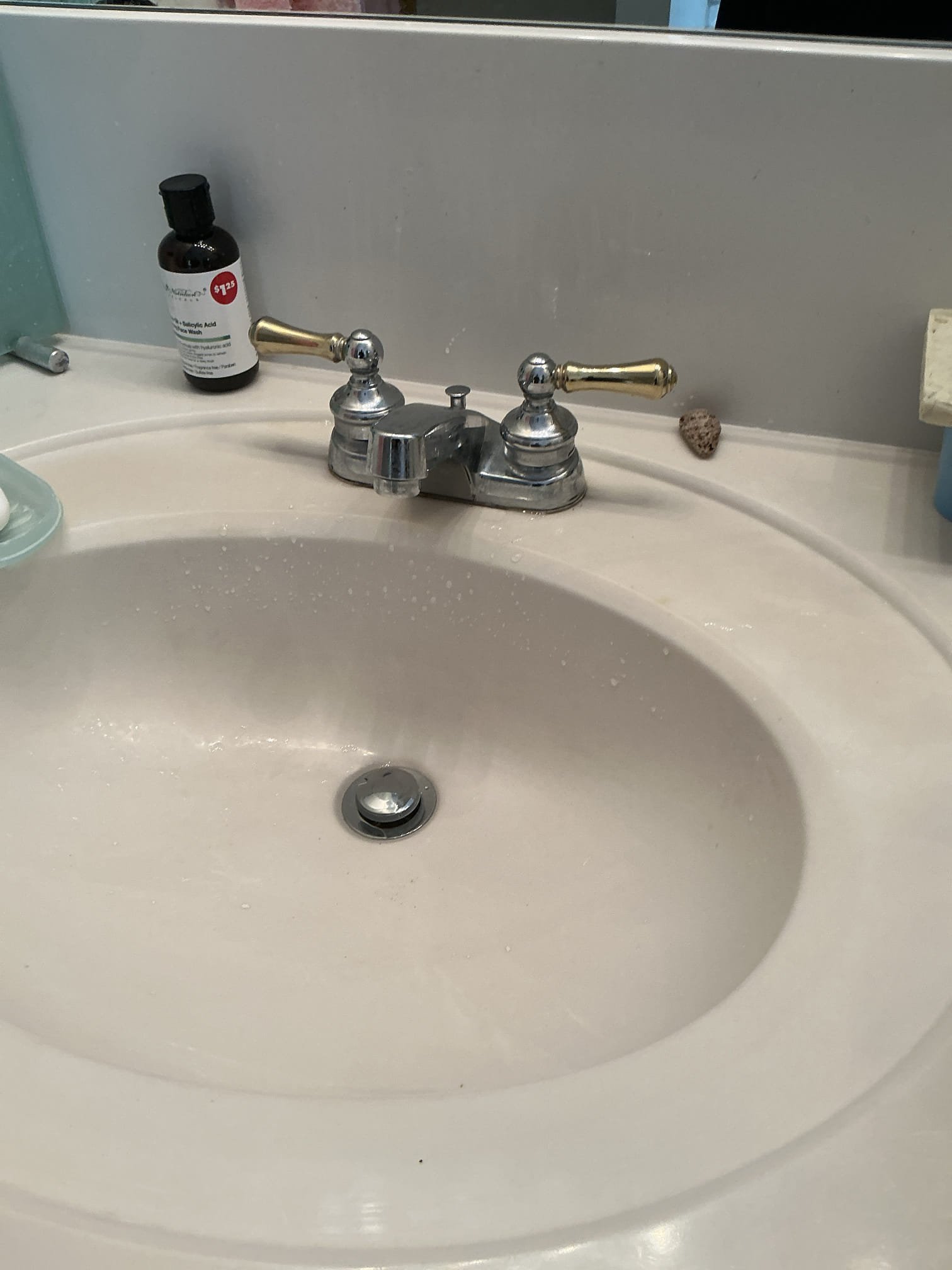 Diagnosed lavatory leaking into cabinet below. Found pop up assembly missing connection rod causing water to leak out of rod hole in cabinet below. Disassembled Ptrap and removed old pop up assembly. Installed new push pop up assembly and reassembled trap. Tested new pop up for proper operation and no leaks found after work completed. Cleaned workspace