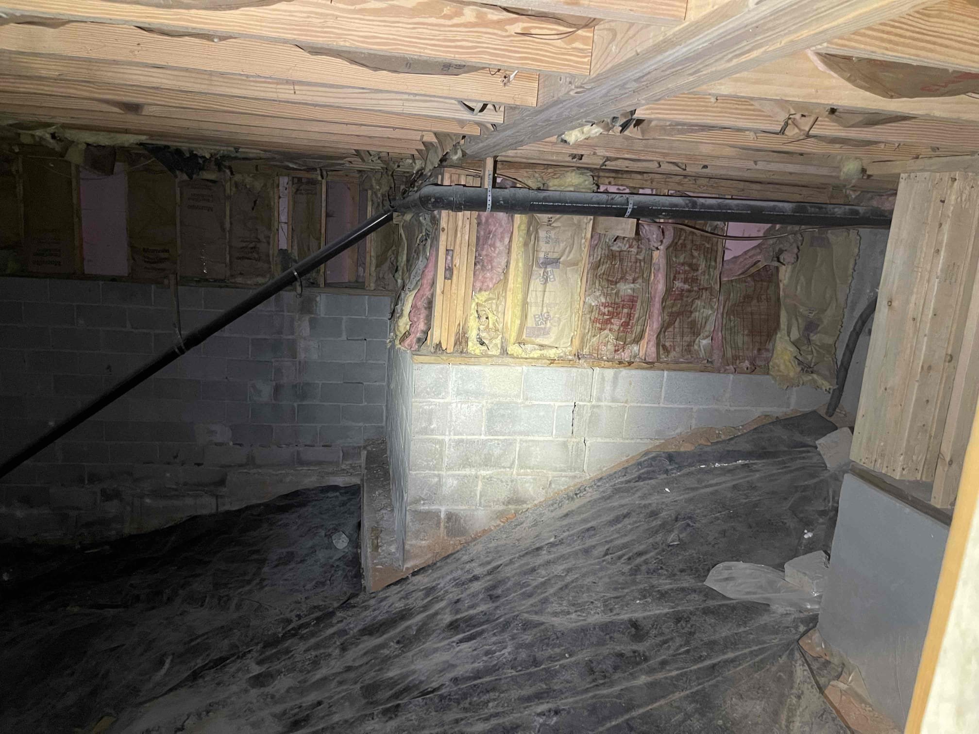 Install customer supplied utility sink and faucet, route copper waterlines with isolation valves to sink. Install hot and cold lines with stop valves. Run 2” pvc drain across wall into crawlspace, route across crawlspace and cut in a new tie in to the 4” abs mainline in the crawlspace. Secure piping to wall. 