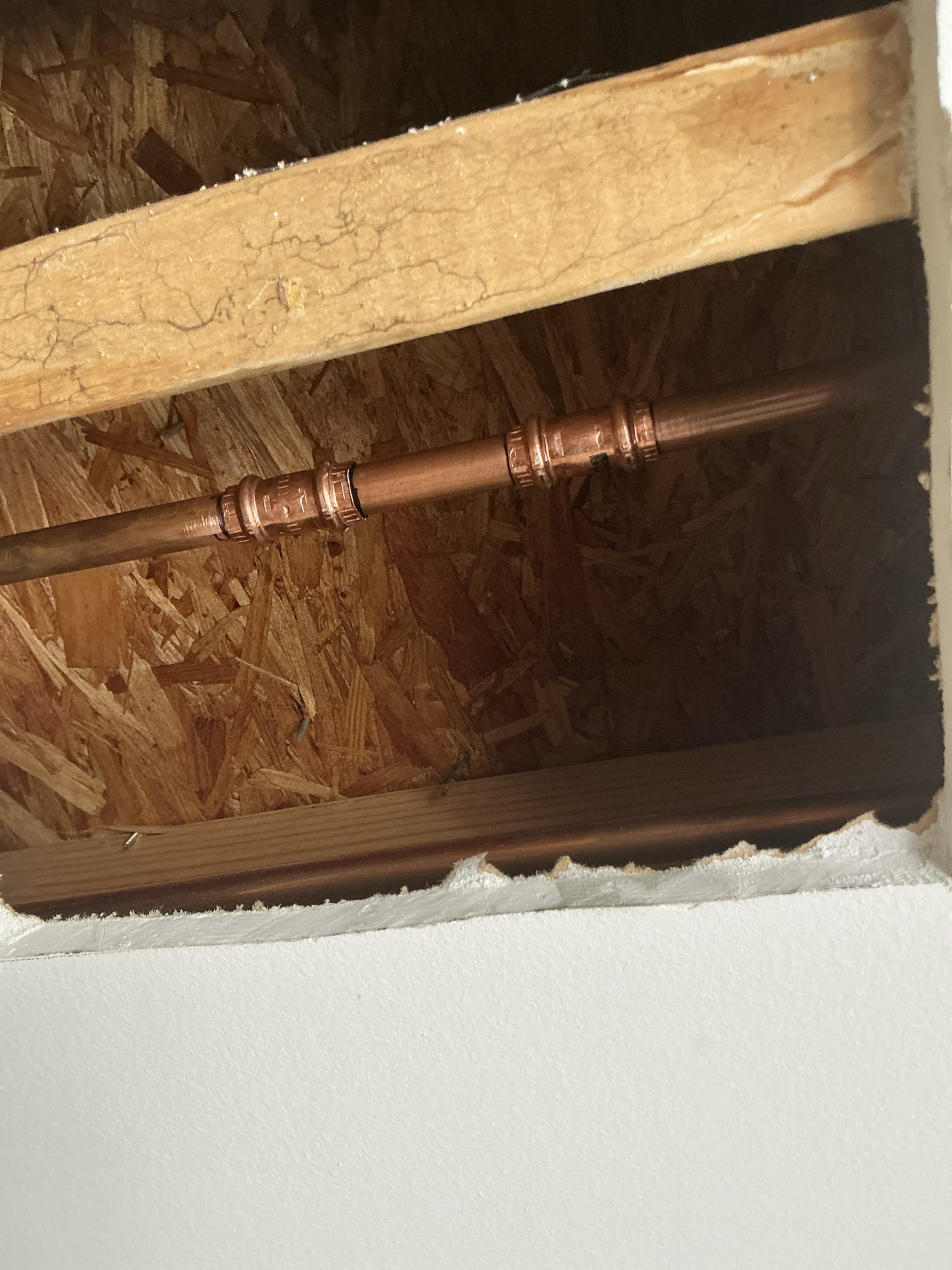 Diagnosed leak on ceiling, checked bathroom above for any evidence of leaks. Did not find any leaks and everything is working properly. With customer’s permission cut sheet rock in damaged area. Cut nice square and revealed a small pinhole in the 1/2 copper line. Shut off water to home and drained system. Cut out section of leaking pipe and replaced with new copper piping. Turned on water and tested work for proper operation and leaks. No leaks found after work completed and cleaned work space 