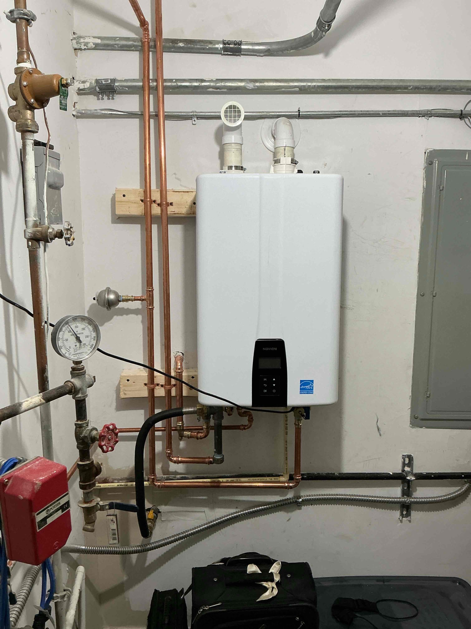 Customer had old electric water heater and looking to replace with tankless. Gave customer options and after approval began to install Navion 240 a tankless water heater. Removed old heater. Mounted new heater to wall. Ran vent out back of wall. Secured all piping and reconnected recirculation line. After installation was complete checked for leaks and proper function. Courtesy item of hose bib install will be done with filtration install at a later date. Will also look into new face plate for tankless heater. Gave customer quote for filtration install.
