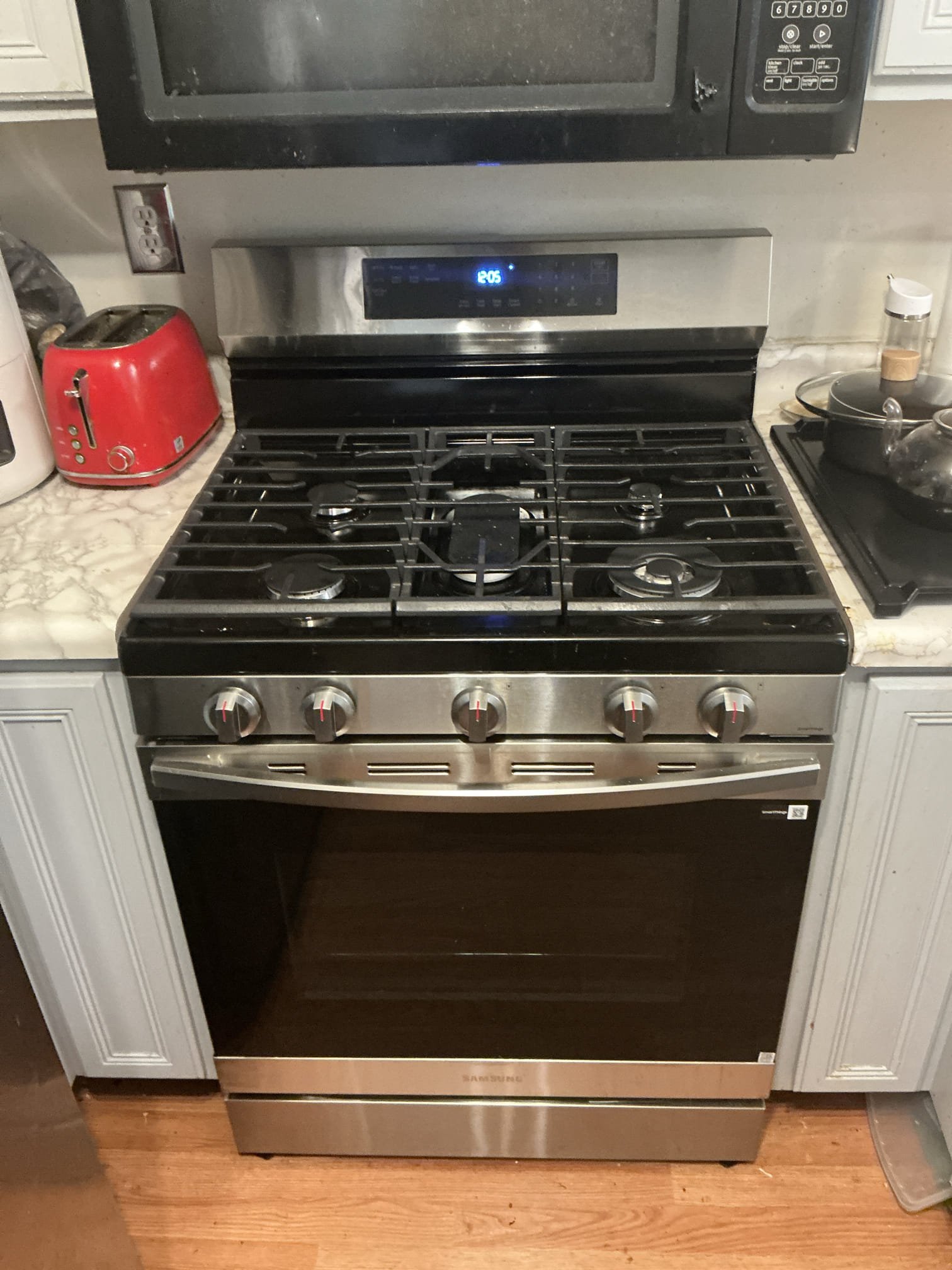 Diagnosed issue with stove not sitting flush with wall. Pulled back stove and noticed piping was in the was and not allowing stove to move back all the way in. Turned and set gas line to side and allowed stove to move. Set stove flush to the wall. 

Left estimate for new water heater 