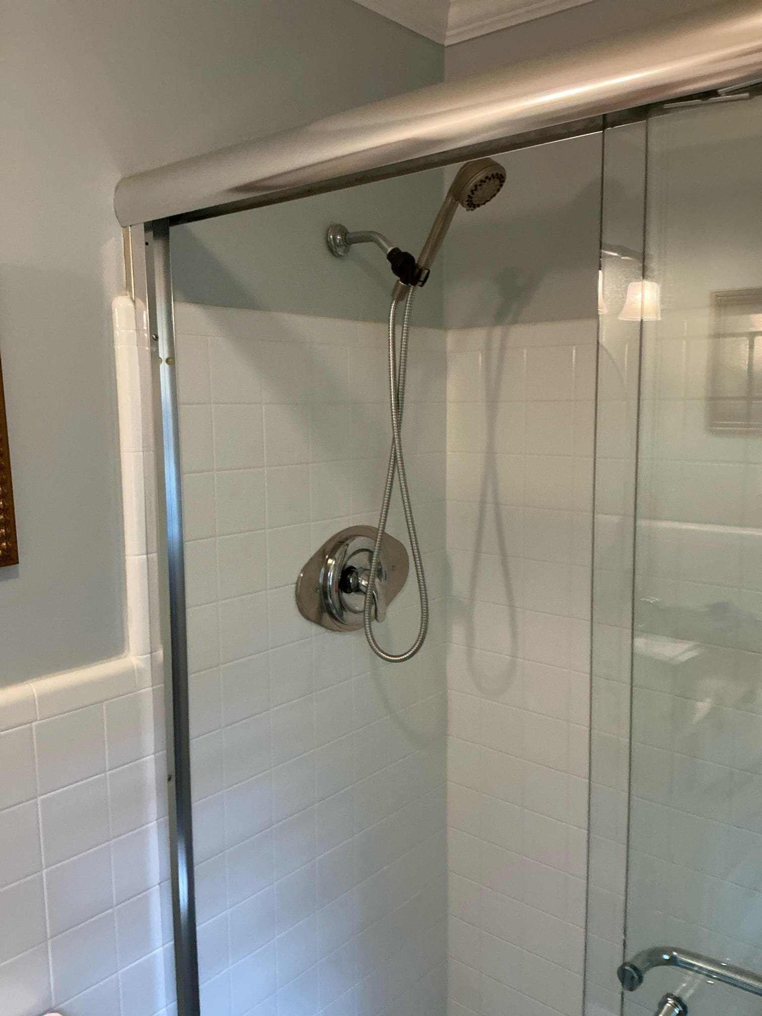 Found back restroom tub and shower valve constantly dripping. Customer did not want wallpaper cut so removed tile from front of 2 handle valve. Installed new moen single handle valve. Installed cover plate to seal penetration through tile. Installed 1” moen handle extension due to wall thickness. Trimmed and tested shower. Left everything in good working order.