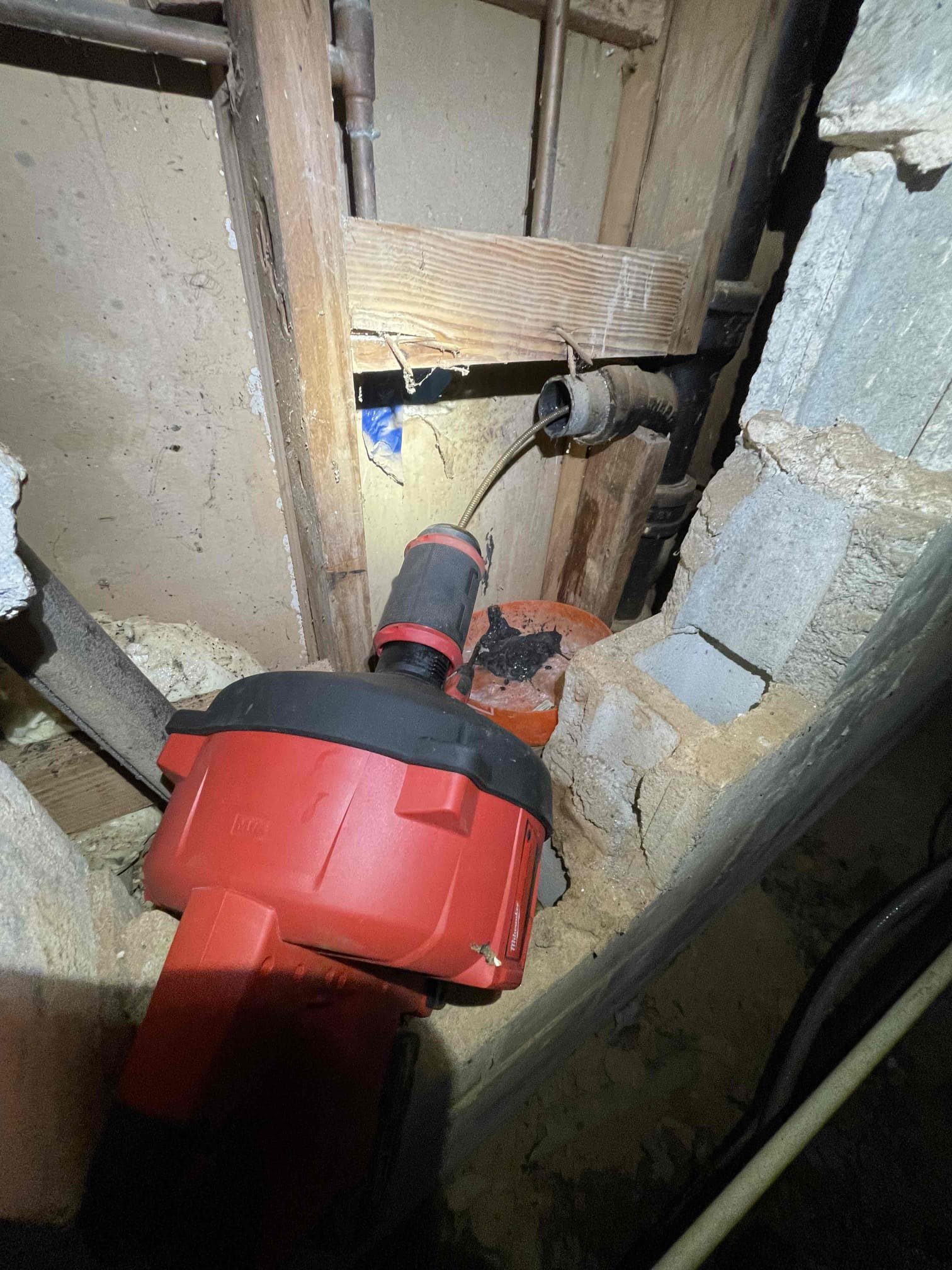 Came out for a sink not draining. Tenant directed us to the pedestal sink in the bathroom. We confirmed drain was holding water and the p trap was free of instructions. Found the condensate line for the hvac is also connect into the same stack and was also holding water. We notified landlord and received approval to replace section of drain and snake out the cast iron. Removed the branch arm to the sink. Ran snake down the line and broke up the build up. Flushed it clean by running hot water from the water heater through a hose down the pipe. We also snaked out the condensate trap and also flushed it out. Confirmed water was flowing through the cleanout in the back yard. Camera’d main drain and found a broken section in the pvc by a very large tree and took a picture of the break. Left quote to replace this section of pipe. Bathroom is in a slab with very old cast iron drains running under it. No warranty on drain cleaning services. Took video showing sink was draining properly and con