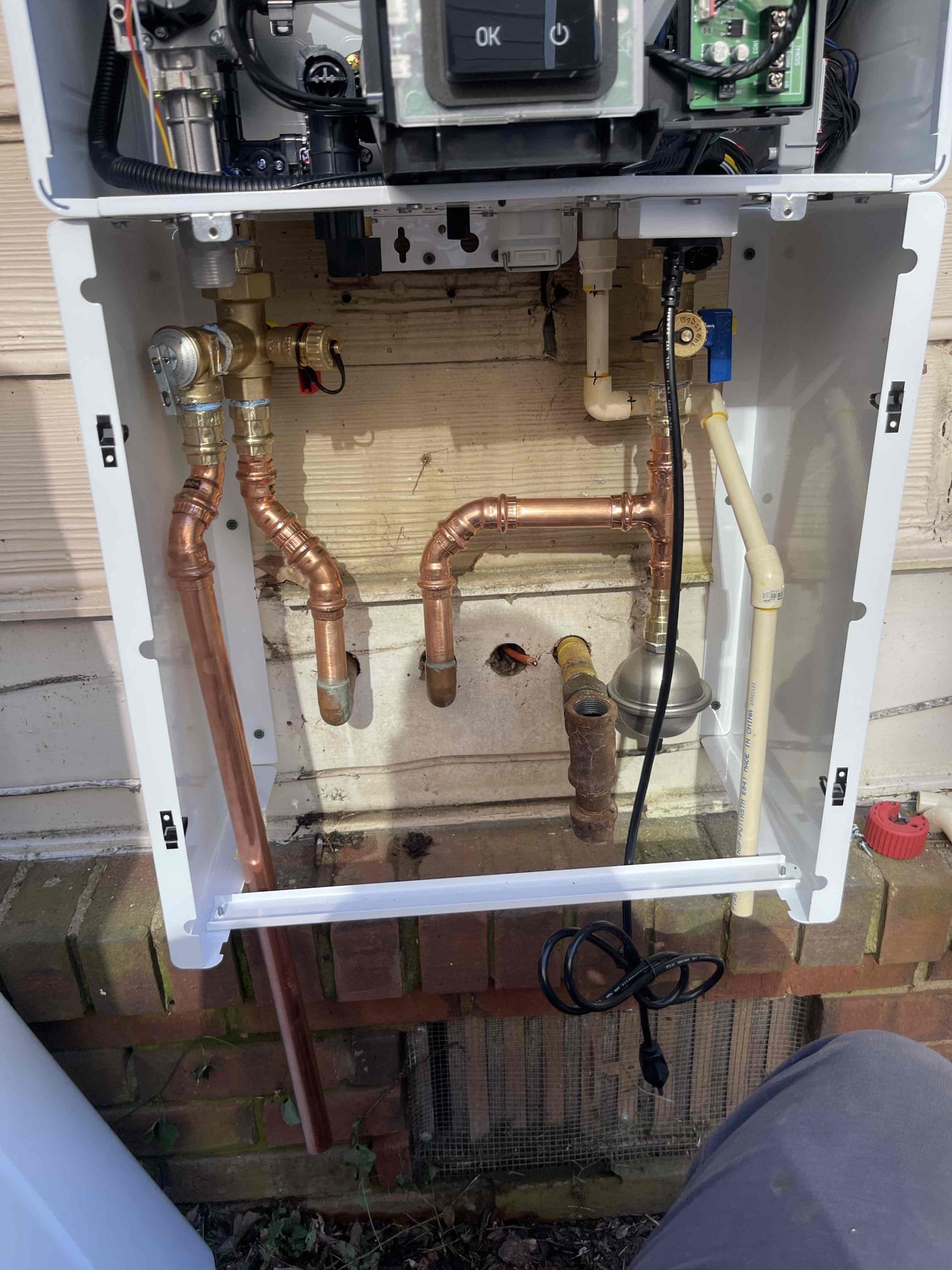 Remove existing tankless water heater on side of home and replace with new outdoor rated Navien 240A2. Will be running drop cord for power temporarily until homeowner can have an electrician come install a dedicated outlet.