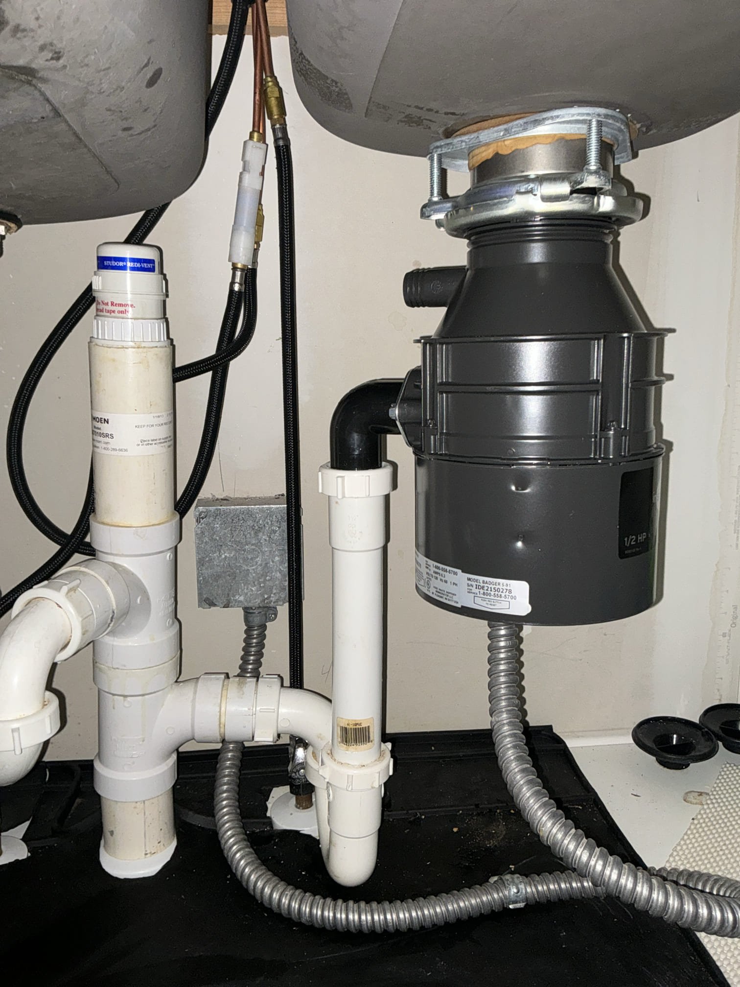 Diagnosed leak coming near garbage disposal. Found disposal from 2013 Leaking internally. Replaced disposal with new one. Reconnected electrical and drain. Slightly reworked drain for better operation. Left estimates for water heater replacement and prv replacement 