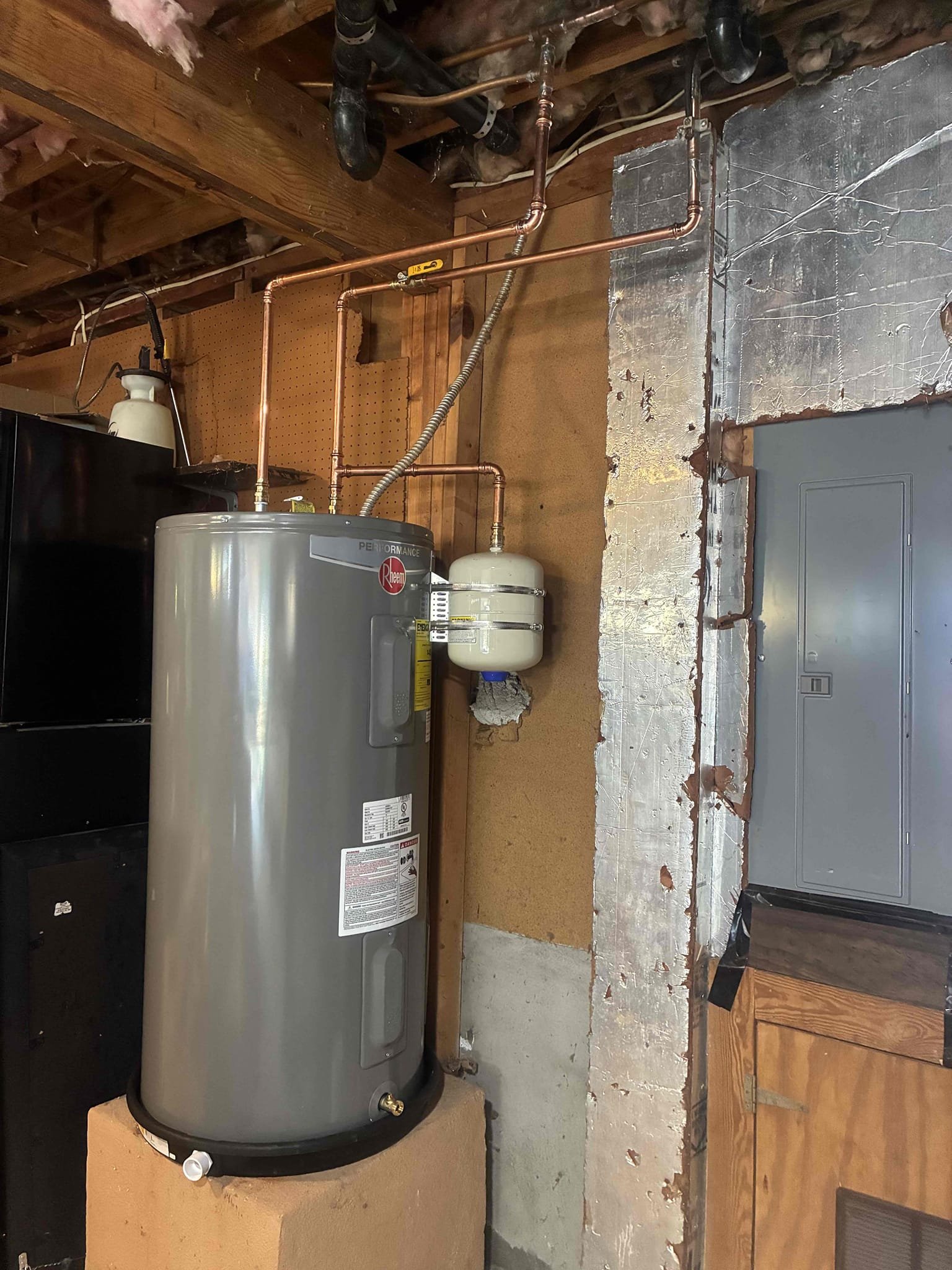 Returning to replace customers aged water heater. Previously left Customer a quote during an inspection. Replace water heater with Rheem 50 Gallon electric water heater. Also installed new ball valve and pan. Replaced small additional section of copper. After work was complete check for leaks and proper function.