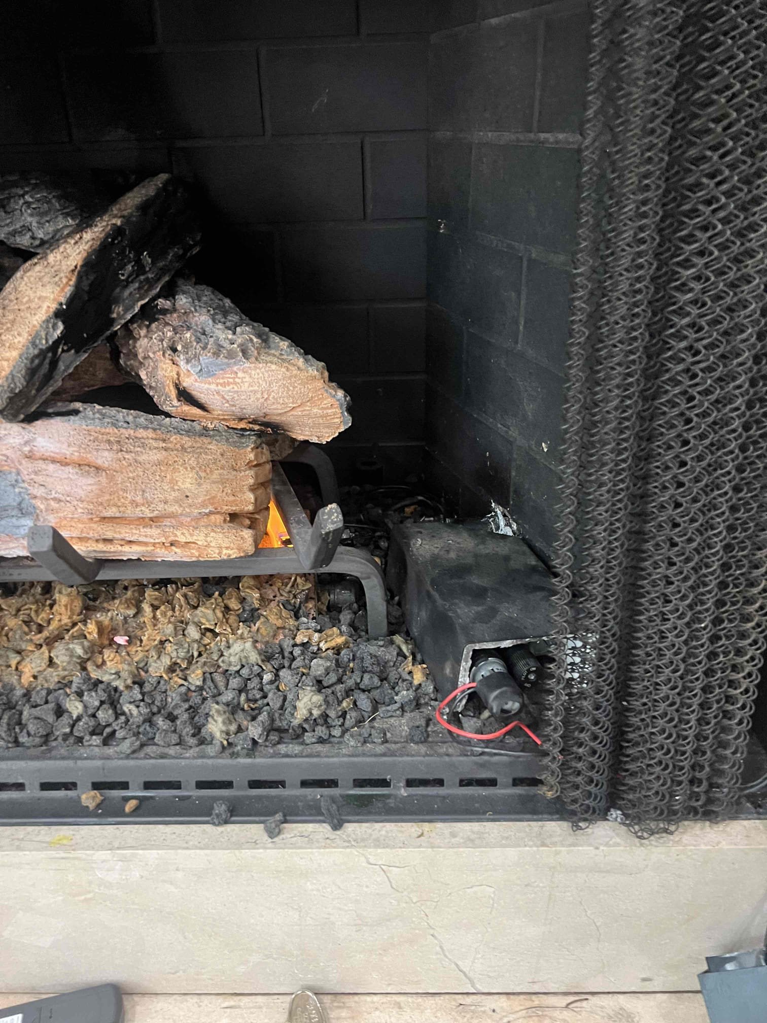 Upon arrival, customer stated they smelt abnormal amount of gas when running fireplace. Gas company cut off valve to fireplace. After turning back on valve, determined gas leak was between fireplace and penetration of exterior wall. Gave option to replace section in order to fix leak. Remove pipe from inside wall and found pipe to have holes in it creating leak after section replacement sprayed new gas pipe and checked for leaks.