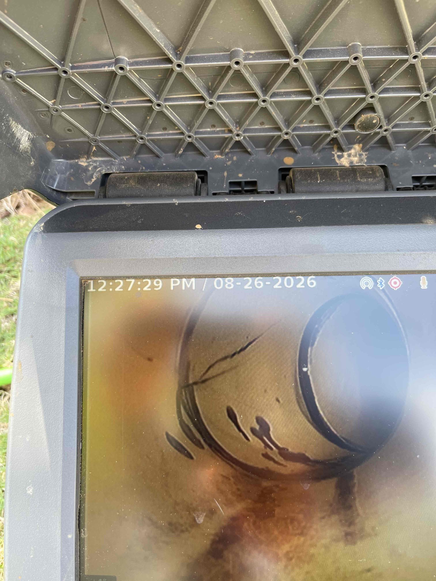 Came out for mainline blockage. Arrived and met with homeowner. He explained that any time a toilet was flushed inside the home, they were getting a lot of gurgling noises. We could not find an outside cleanout, but the city cleanout was shallow enough we could reach down and run the camera up the line from where the drain connects to the city cleanout. We ran camera 25’ up the line and found 2 bellies, and a break with a root intrusion up near the foundation wall. Sewer line pitch has been affected by what appears to be the home settling. Sewer line nearest the house has had all of the buried drain piping sink with the house and drain line is no longer running downhill in sections. We received approval to jet the sewer line. Went and retrieved mainline hydro jetter from our shop and returned. Jetted the roots with 3000 psi and cut the roots out of the pipe. This did restore flow to the drain for the time being, but this is a temporary fix. Jetting did not do anything to address the im